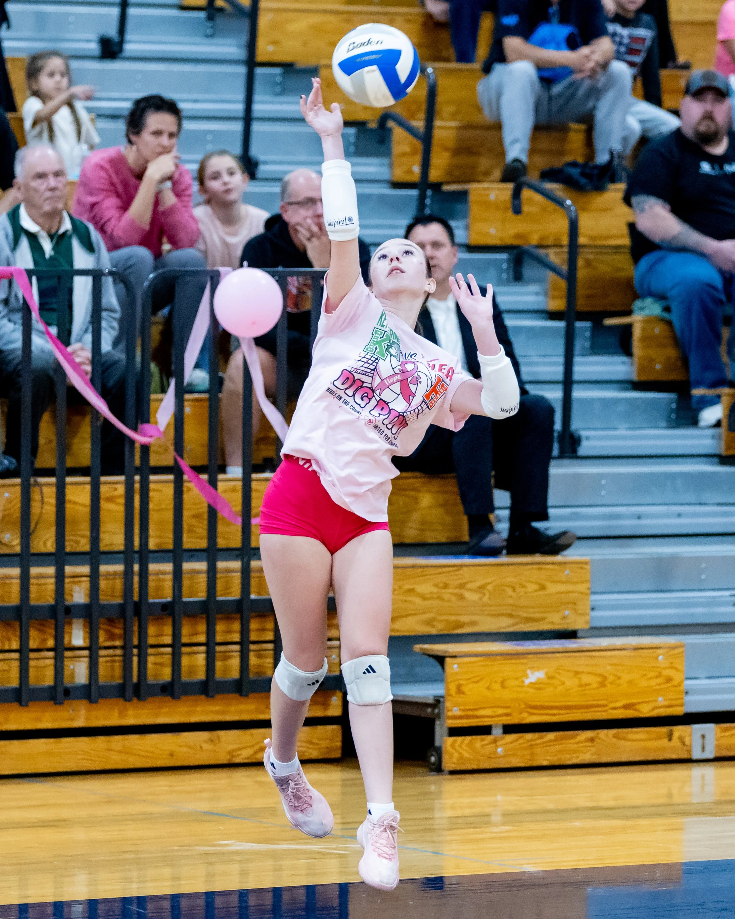 Kettering player serves the ball