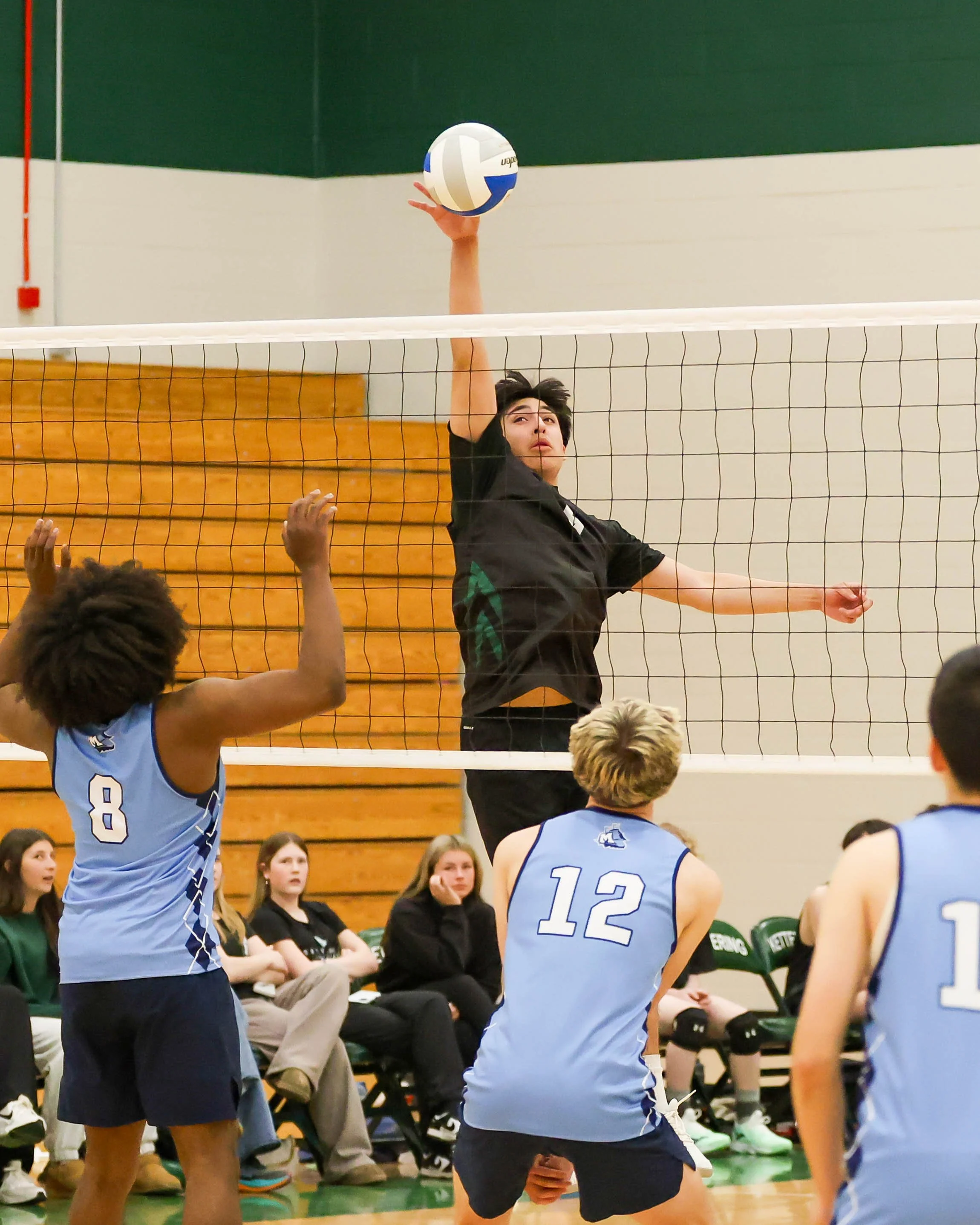 Kettering #9 taps the ball over the net