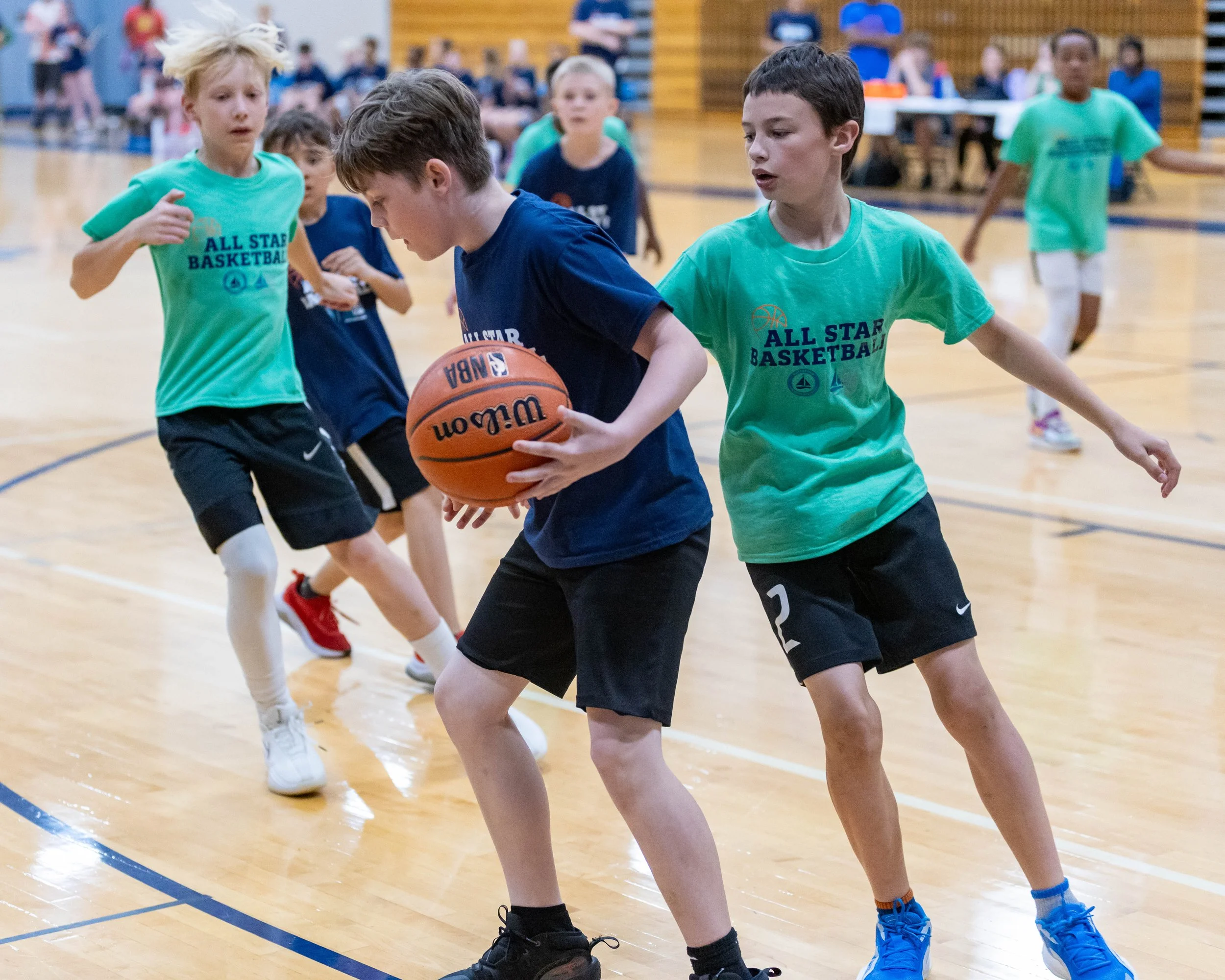North boy with the ball guarded by South boy