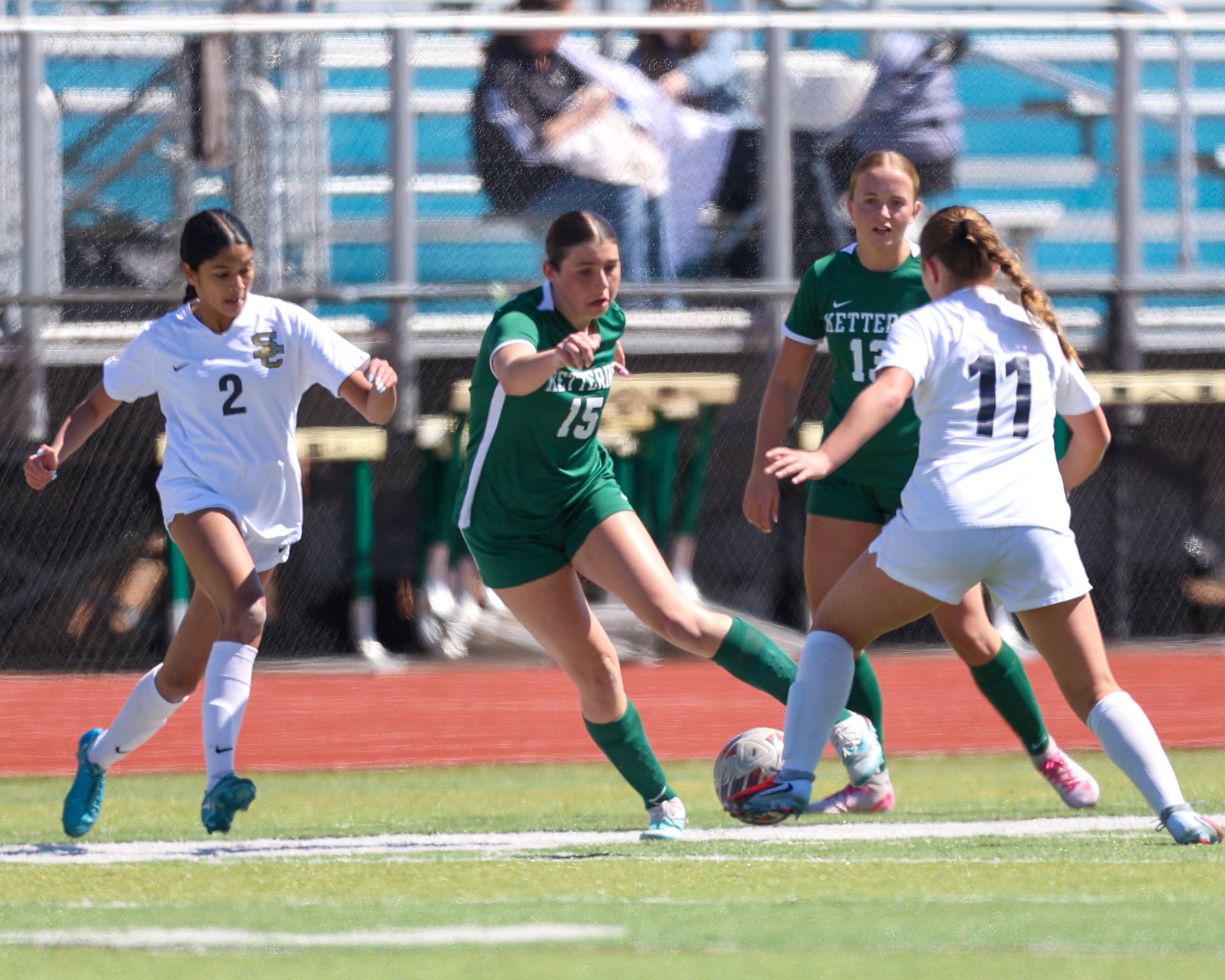#15 between to Stoney Creek defenders