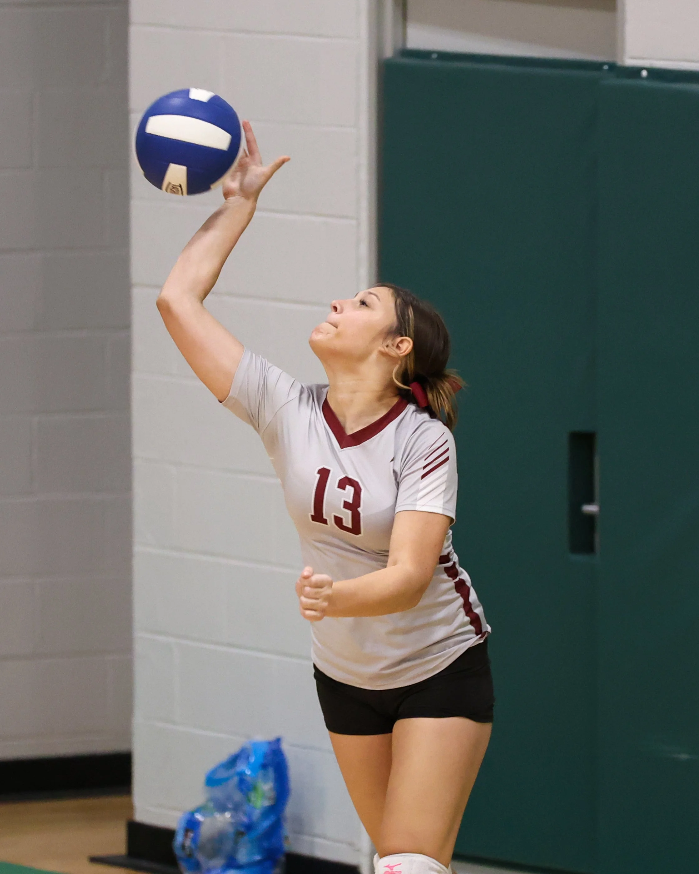 Mason girl serves the ball