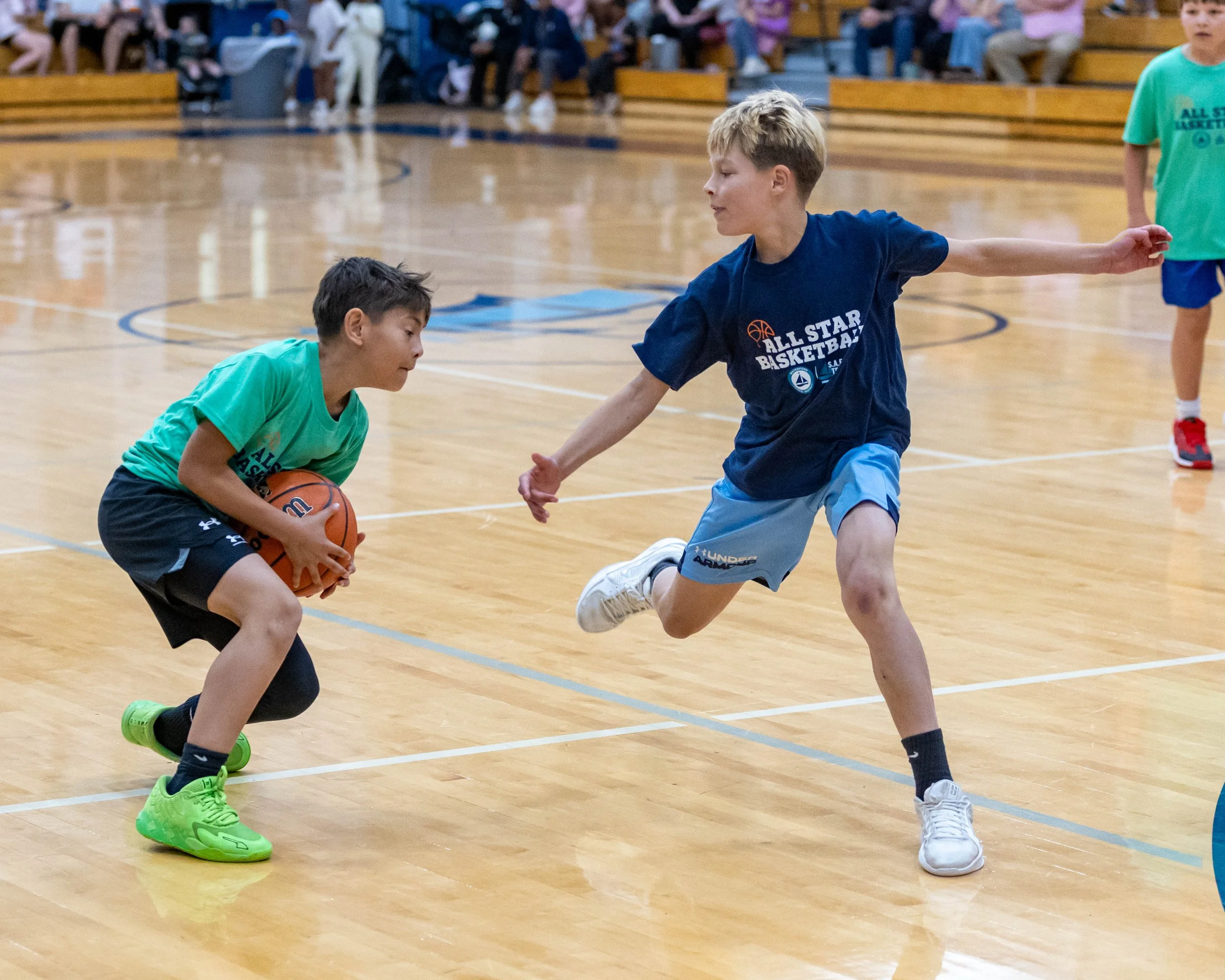 South boy carries the ball as a North player goes by