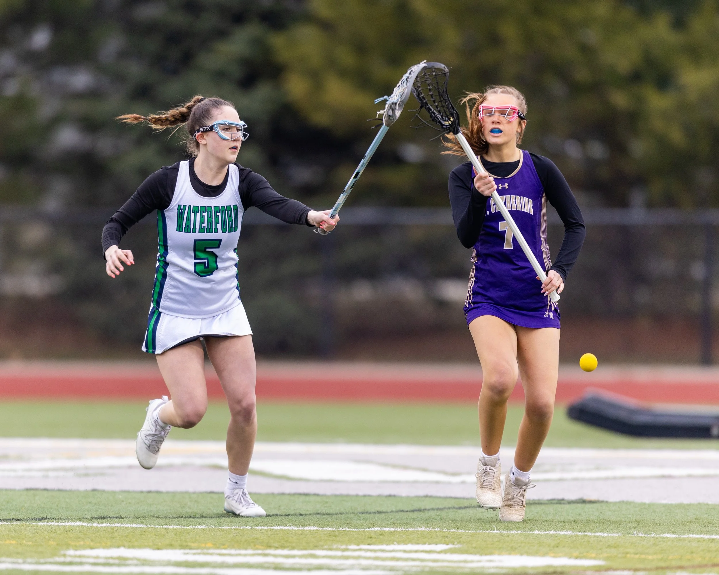 #5 knocks the ball from St Catherine's #7