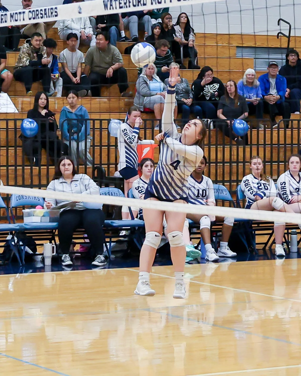 Mott #4 hits the ball towards the net