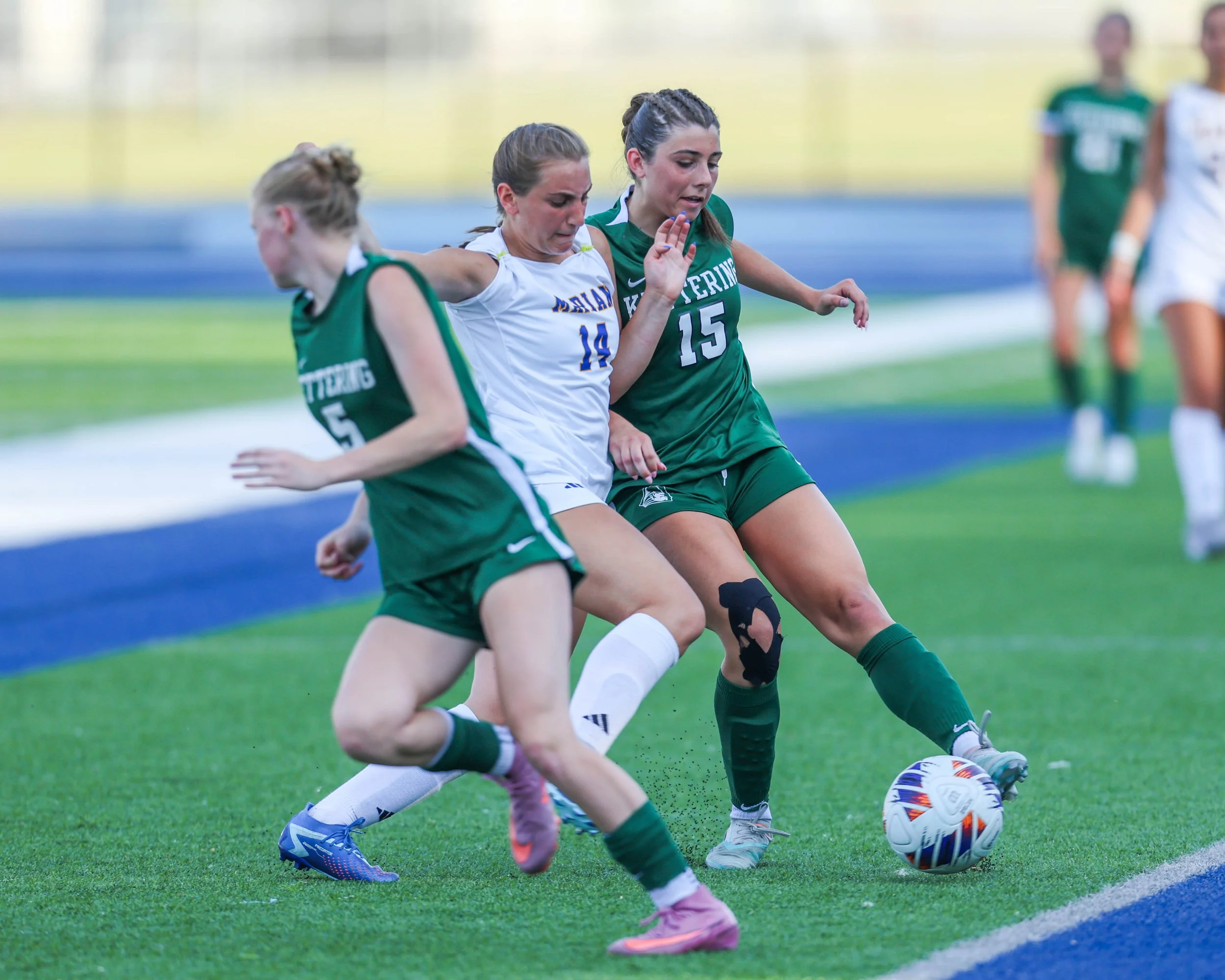 #15 kicks the ball next to an opponent 
