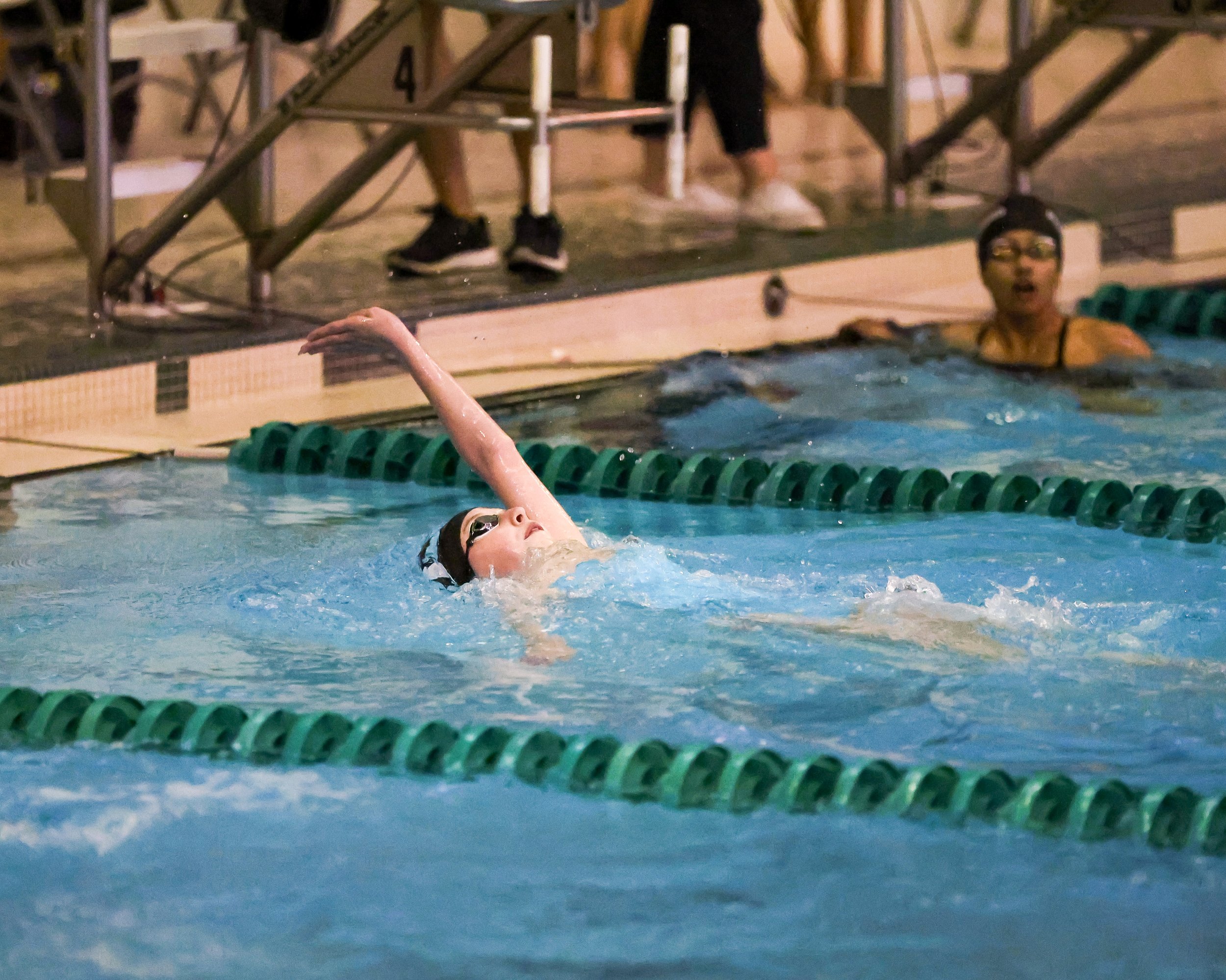 WU swimmer finishes the backstroke