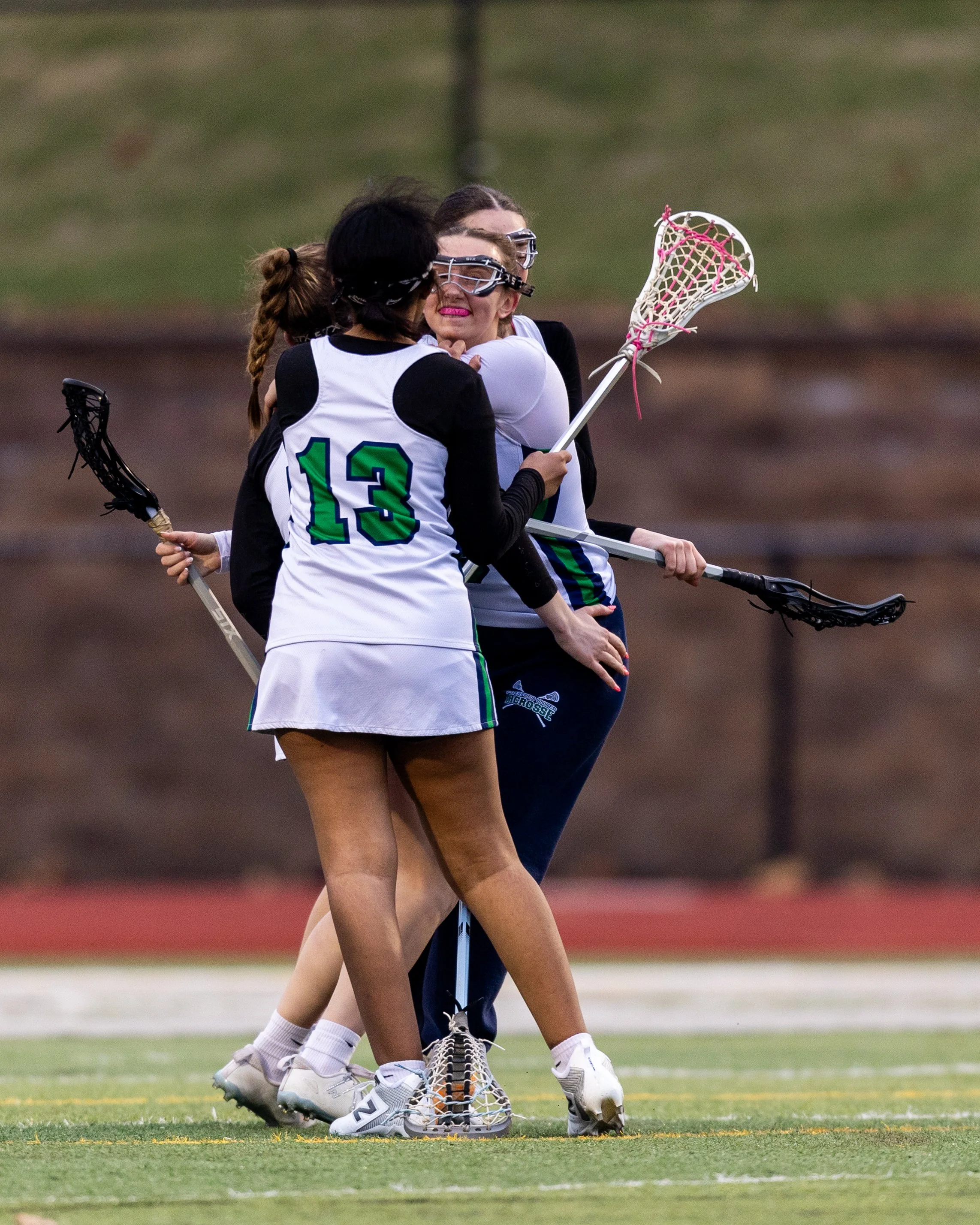 #10 celebrates a goal with teammates