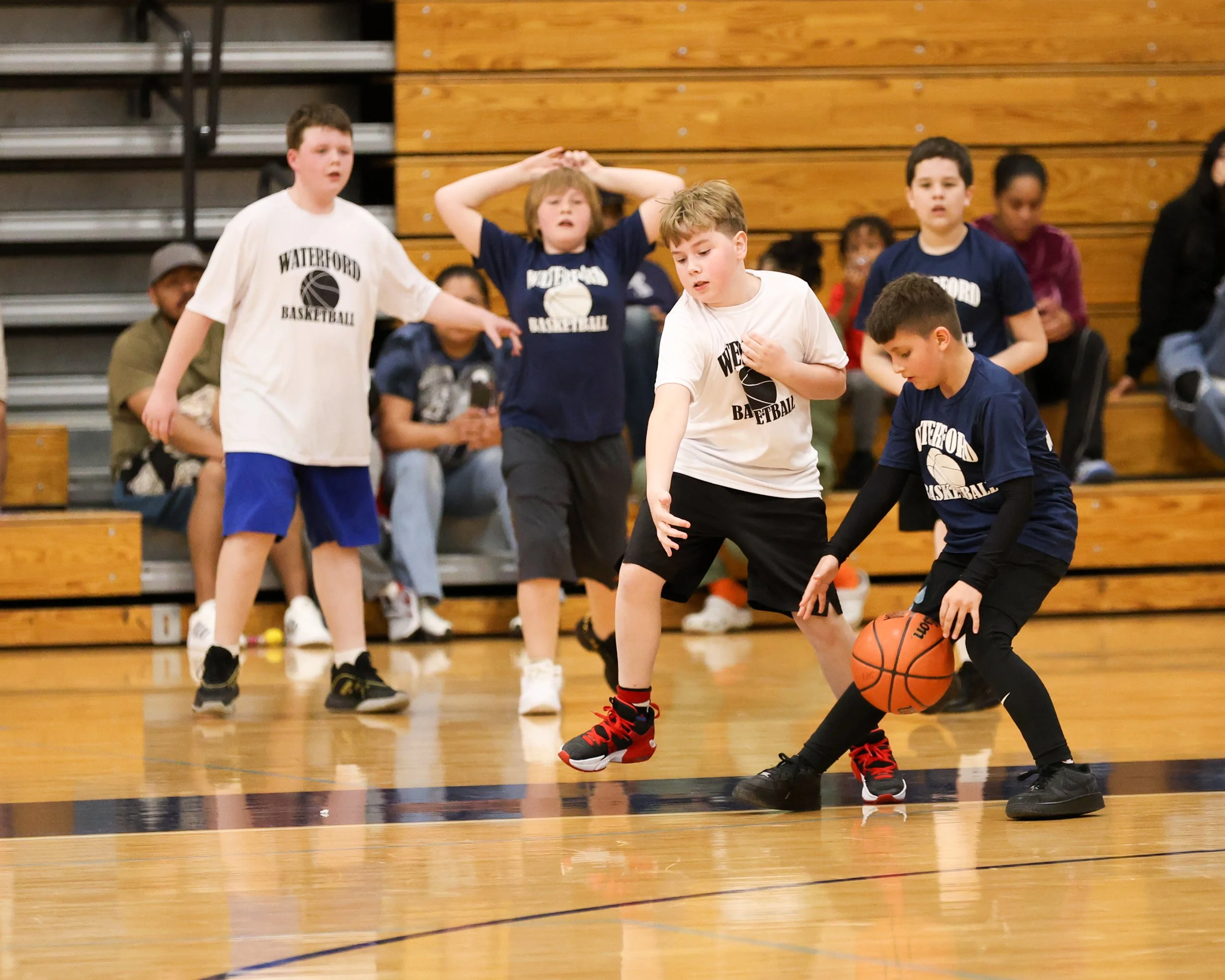 Donelson Hills boy dribbles the ball with several boys in background 