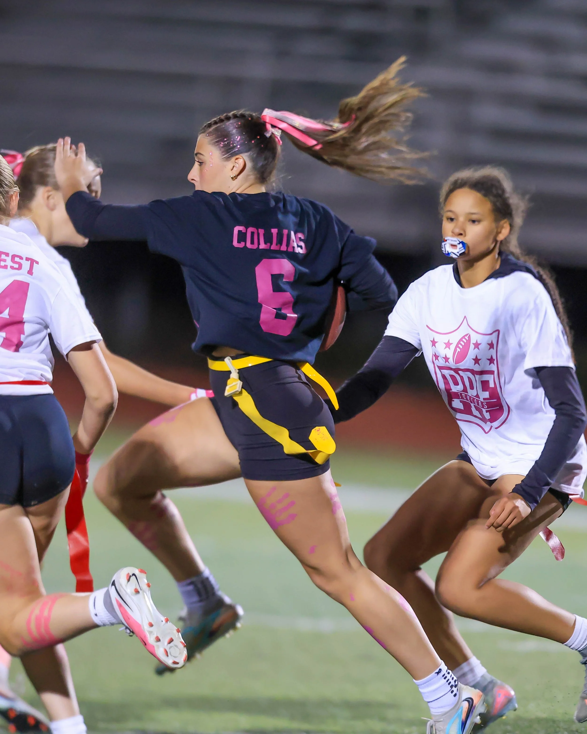 Senior quarterback runs between the Juniors