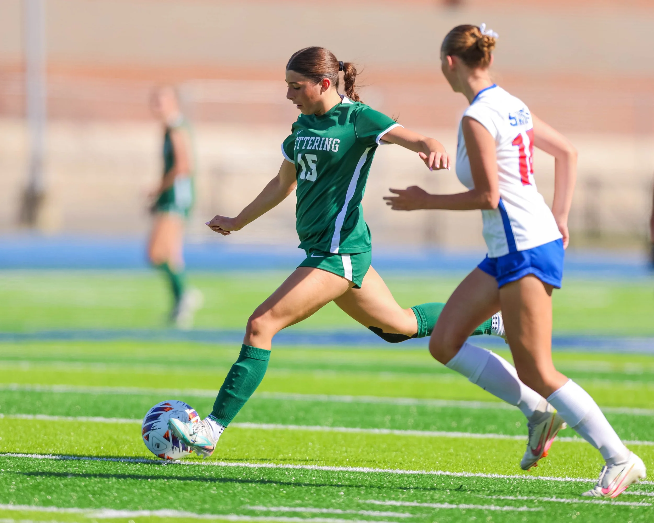 #15 kicks the ball