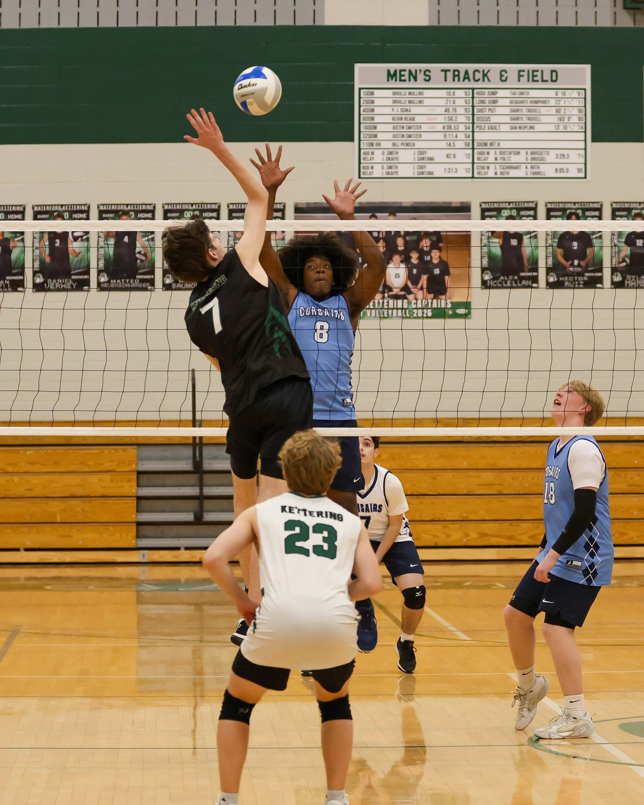 Kettering #7 goes to spike the ball with Mott #8 trying to block it