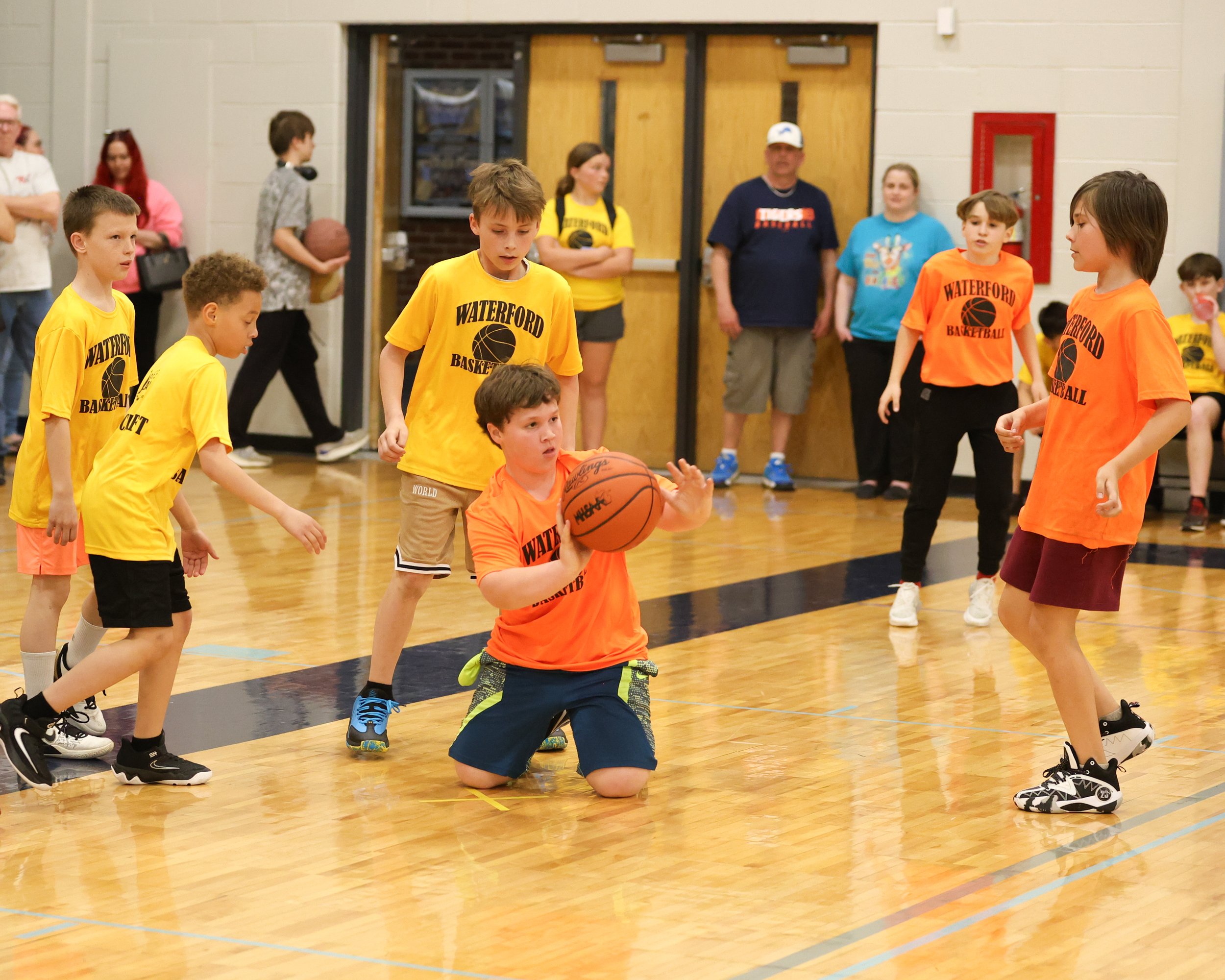 Knudsen boy on knees passing the ball