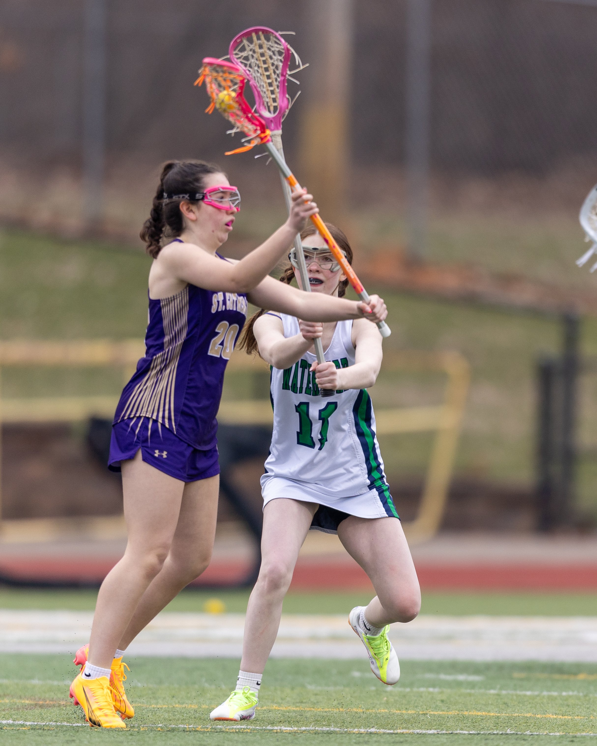 #11 knocks the stick of St. Catherine's#20