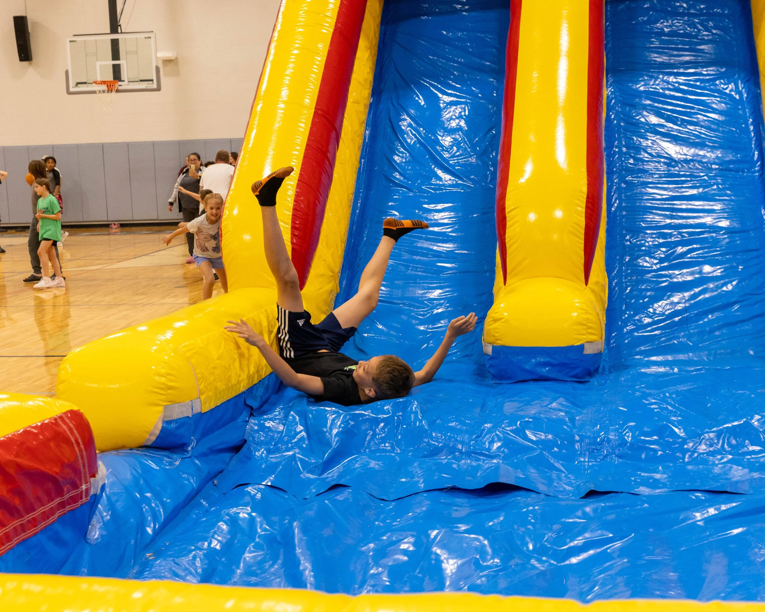 Boy goes down slide backwards