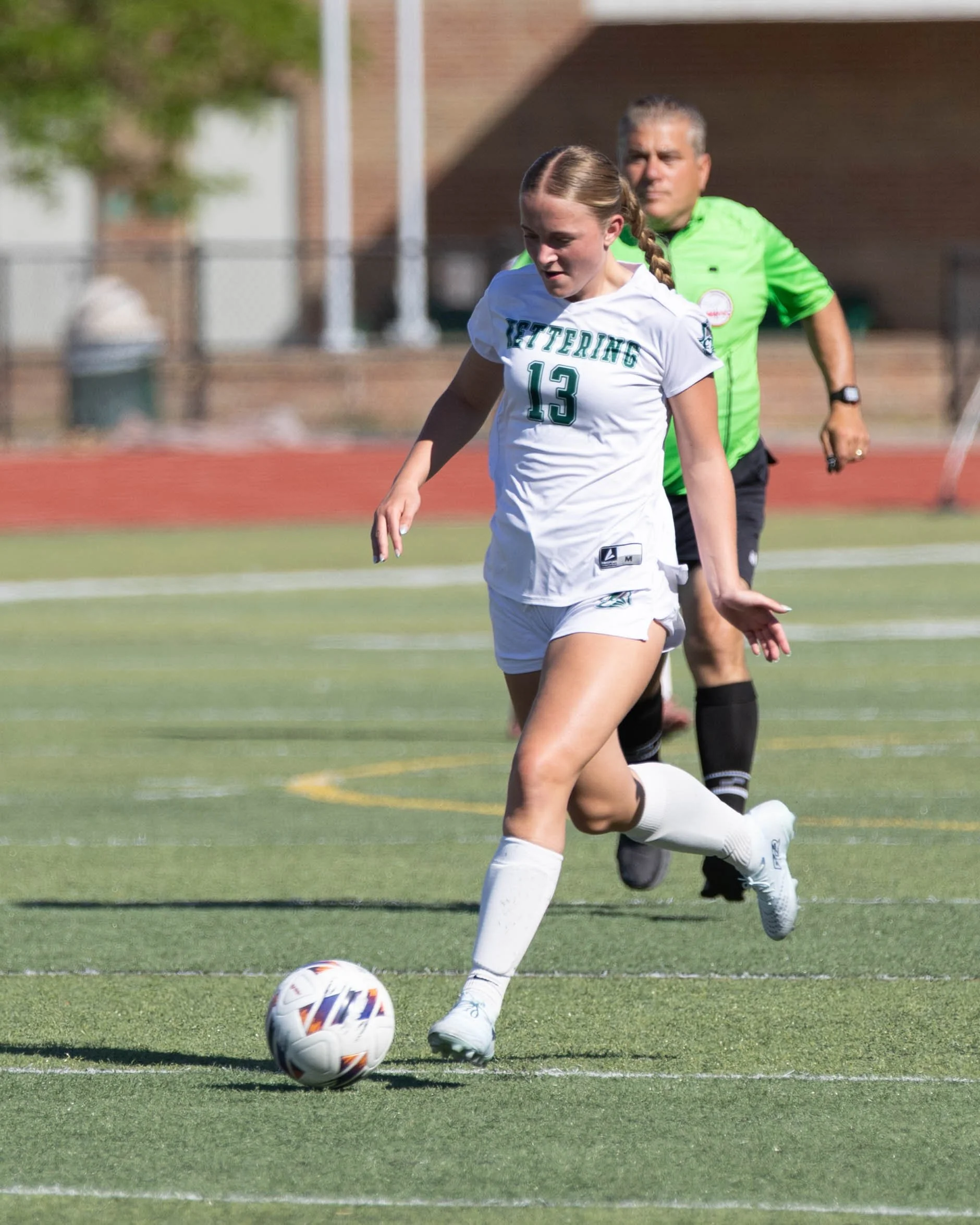 #13 goes to kick the ball