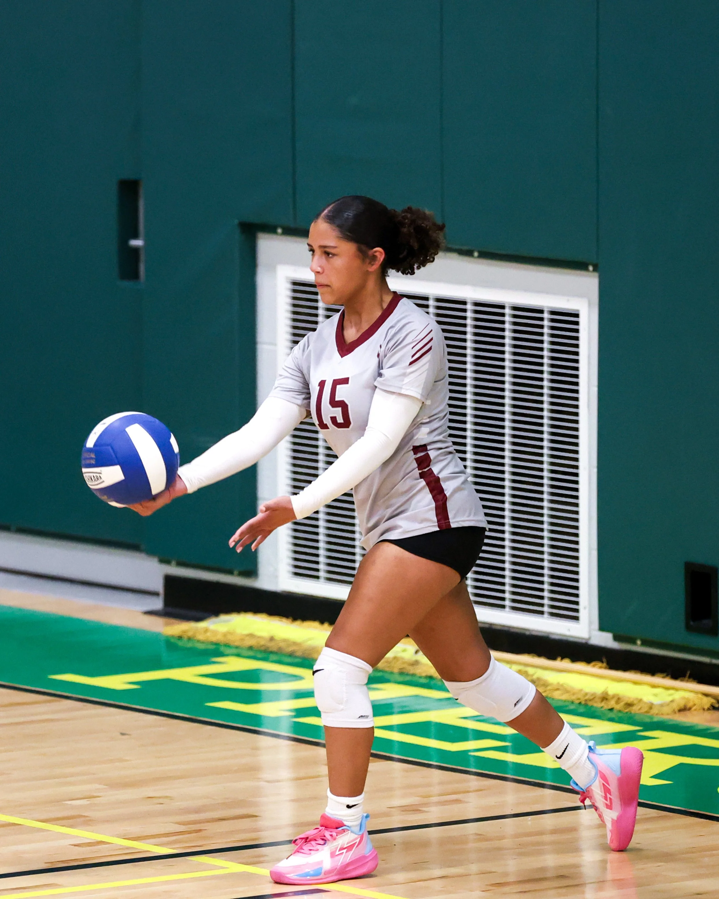 Mason girl serves the ball