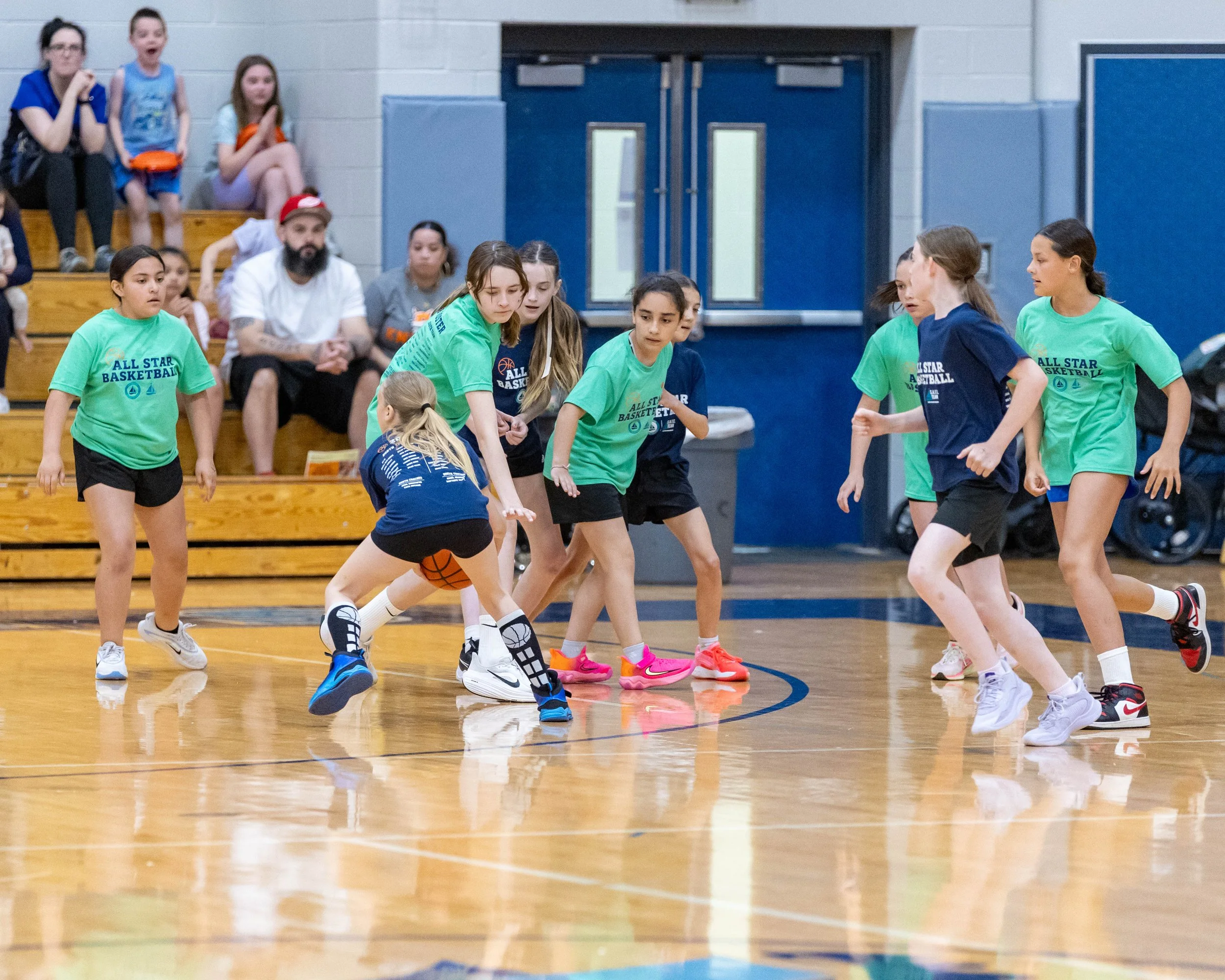 North girl with the ball guarded by two South girls