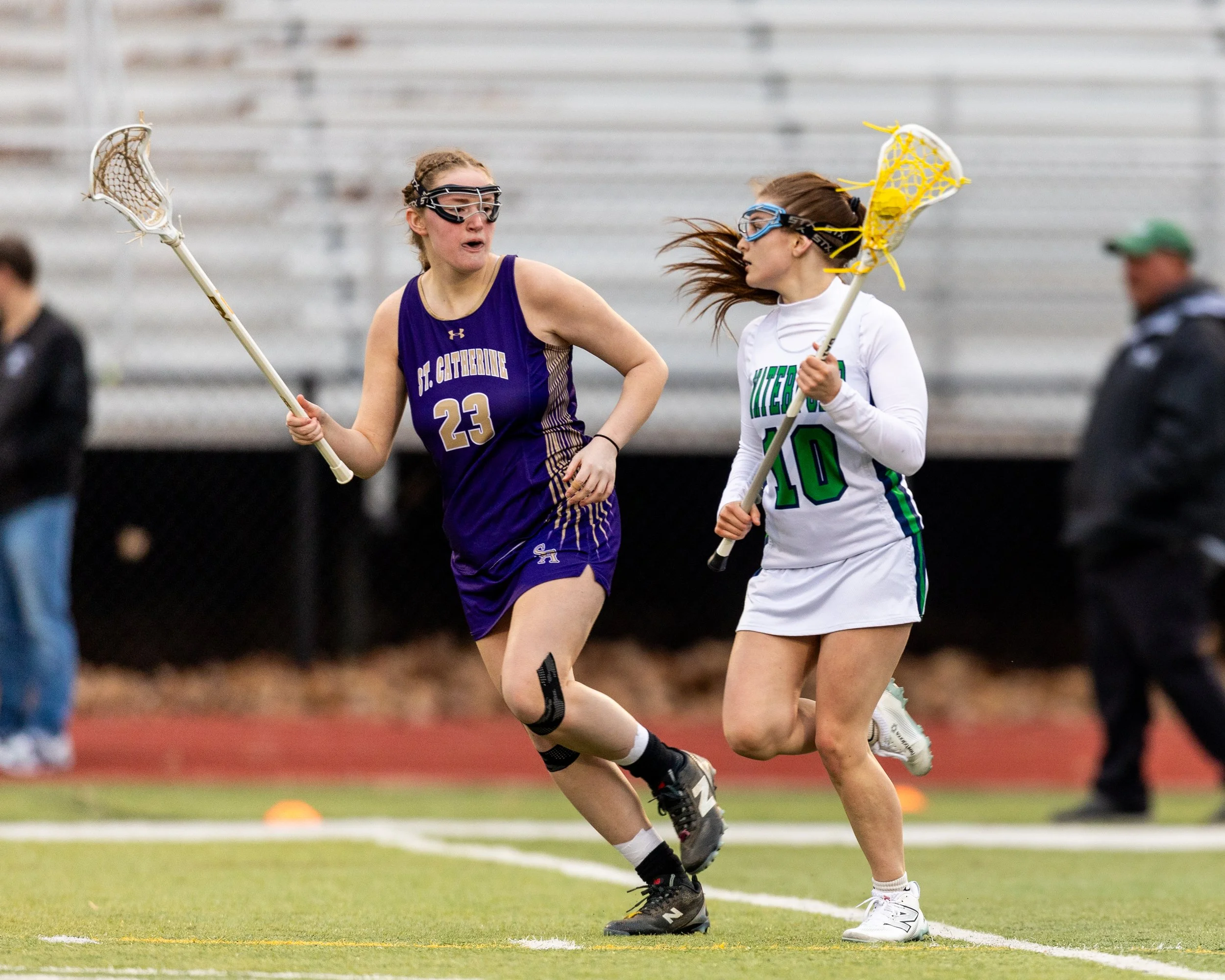 #10 carries the ball with a defender