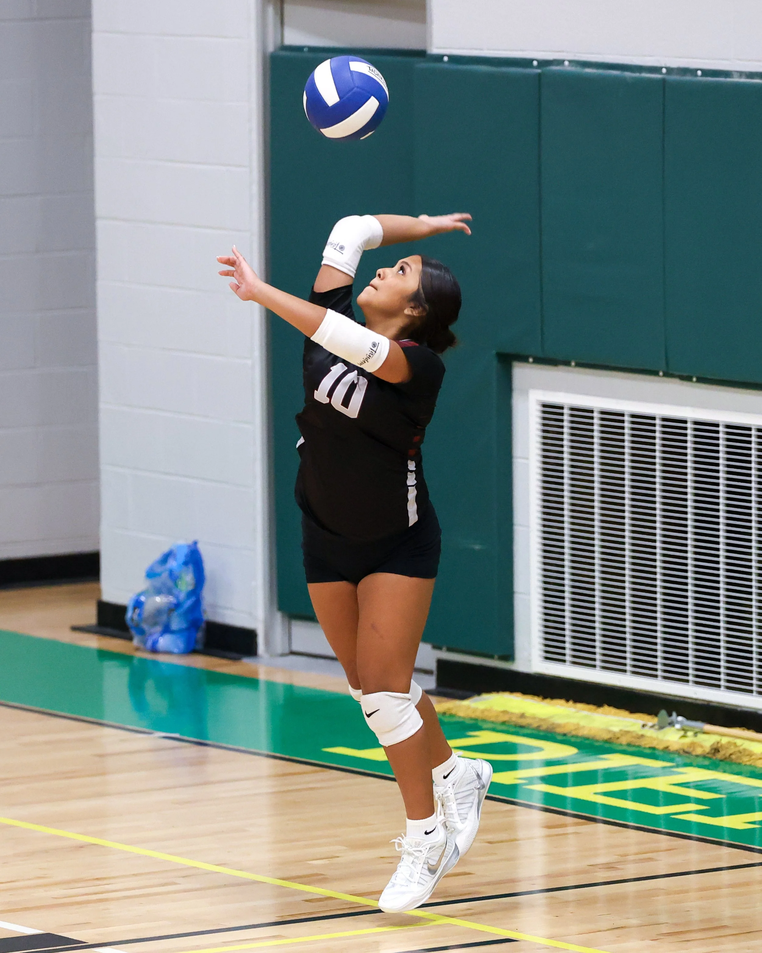 Mason girl serves the ball