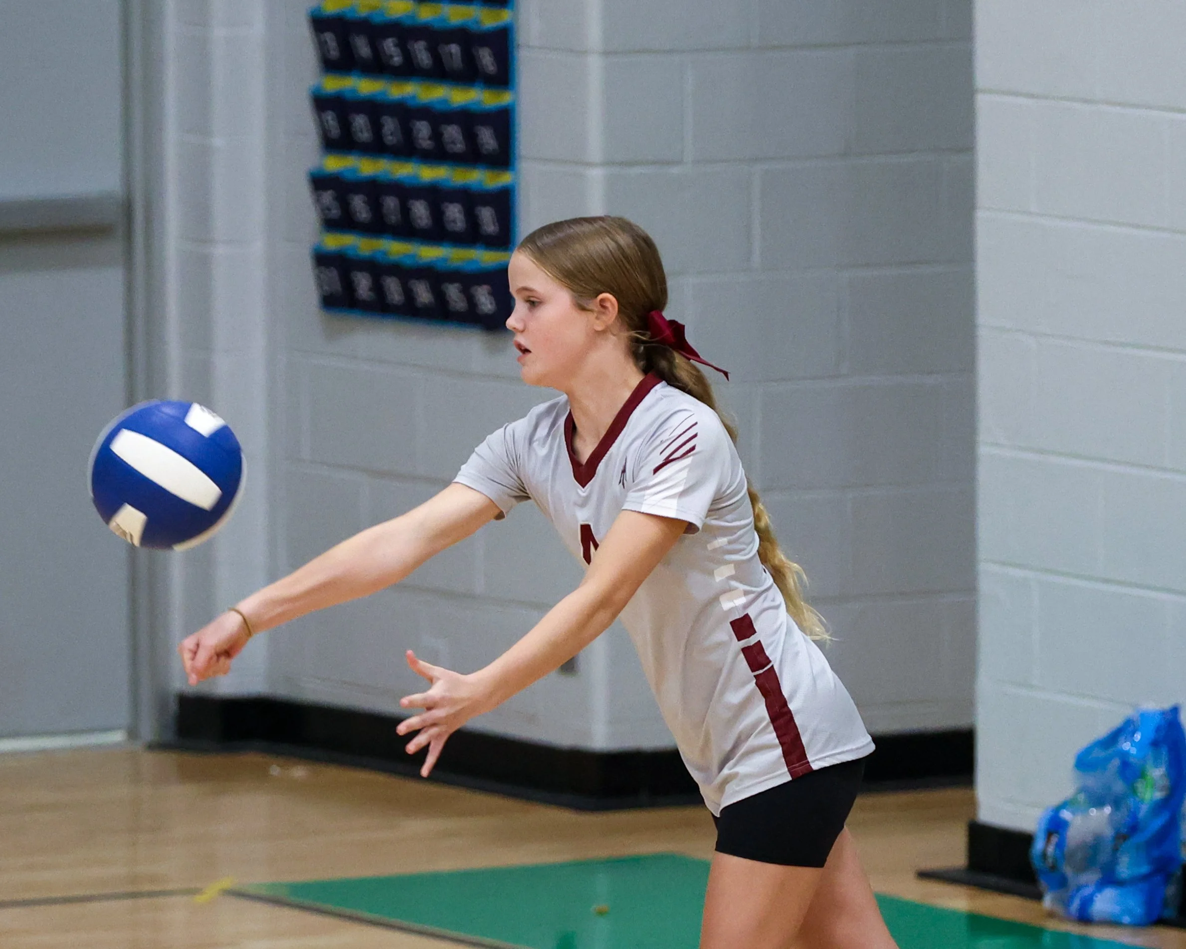 Mason girl serves the ball