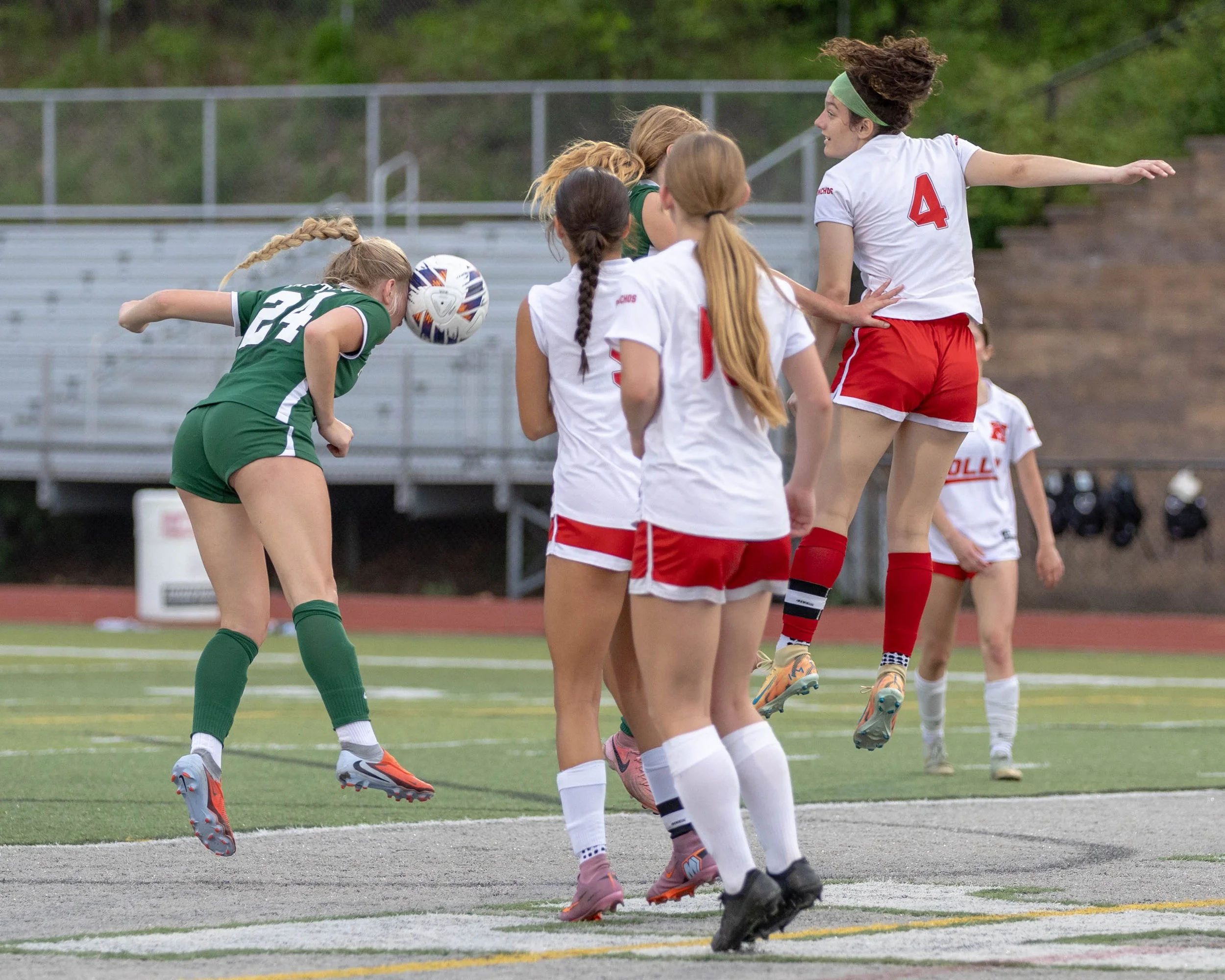 #24 heads the ball