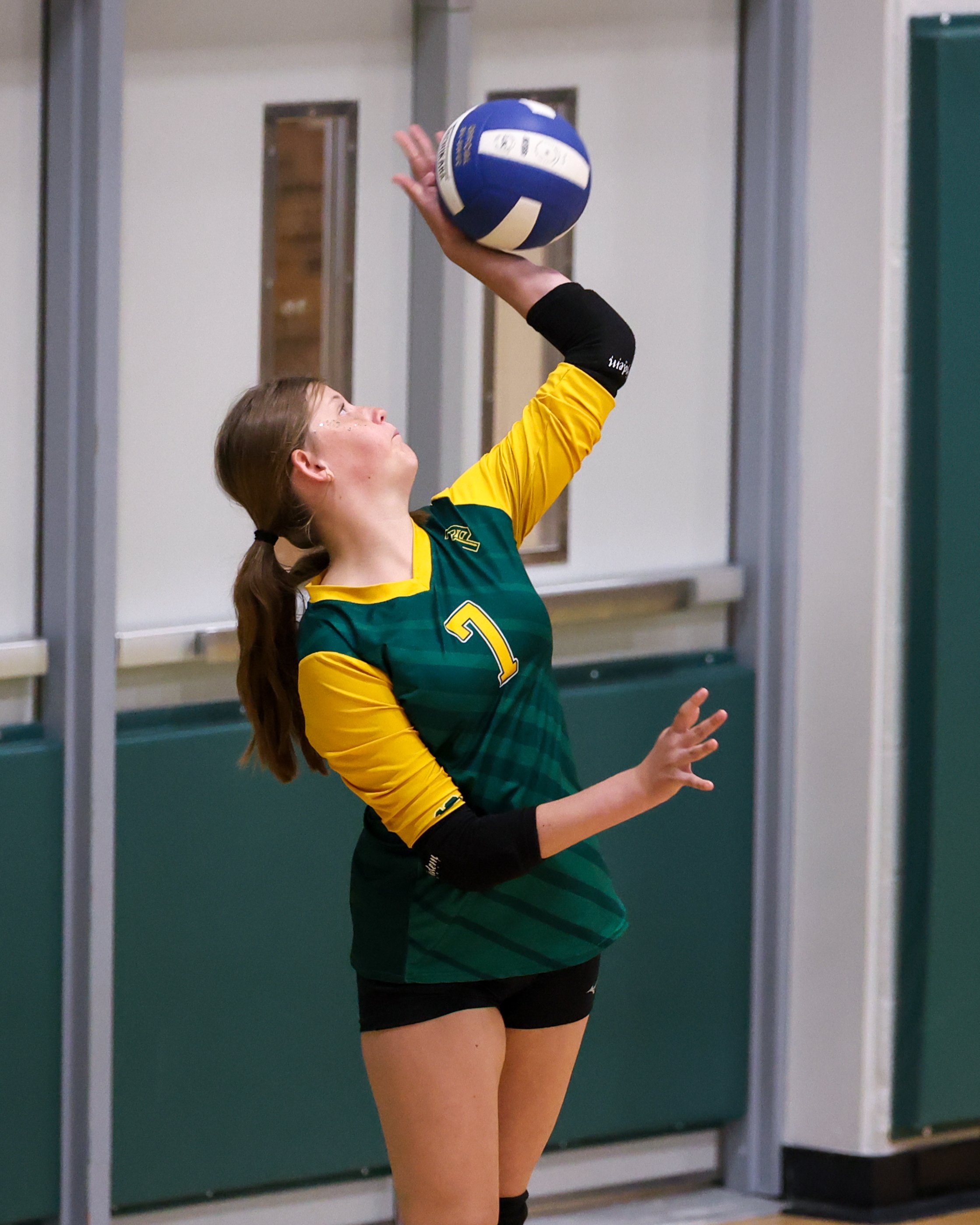 Pierce girl serves the ball
