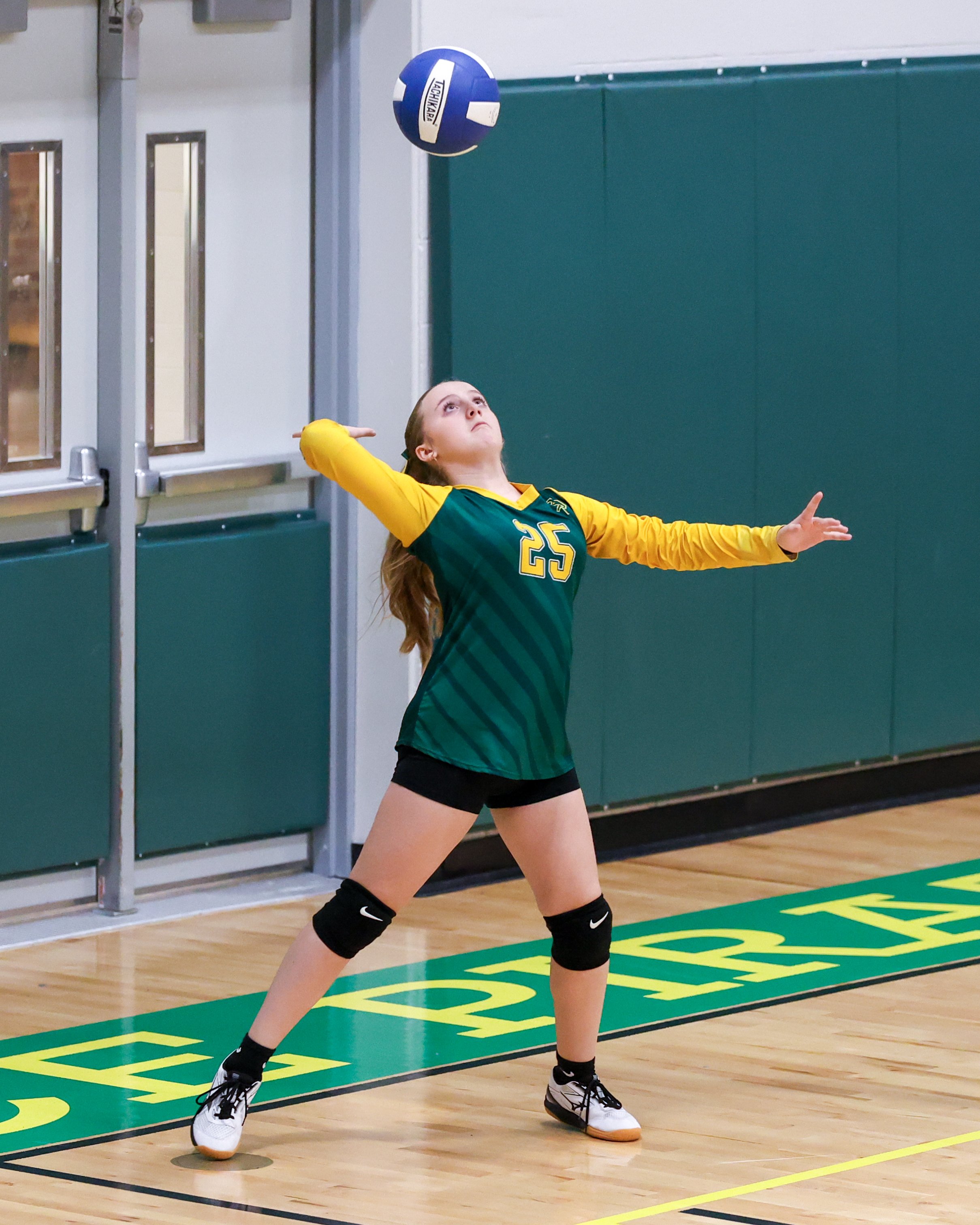 Pierce girl serves the ball