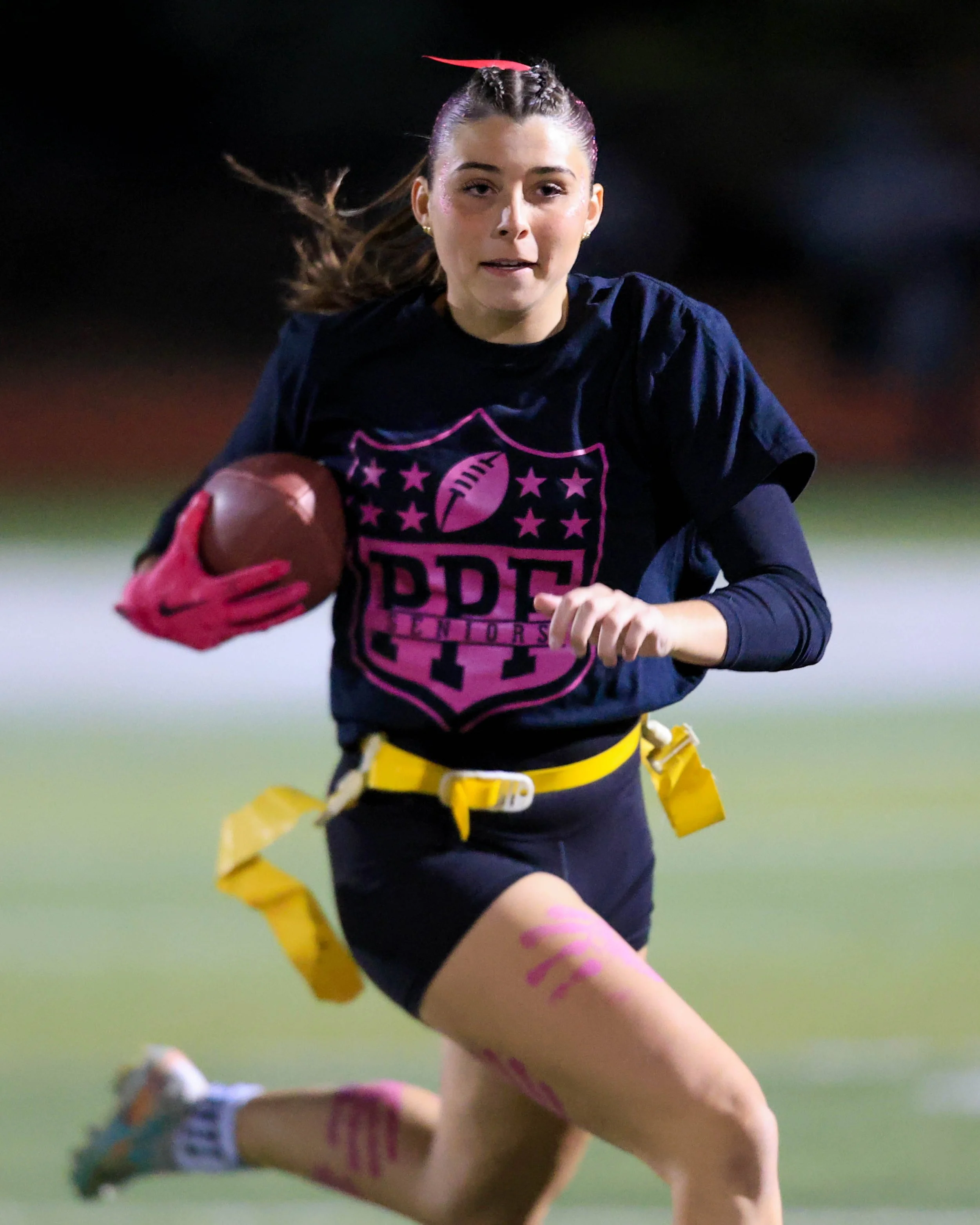 Closeup of Senior running with the ball