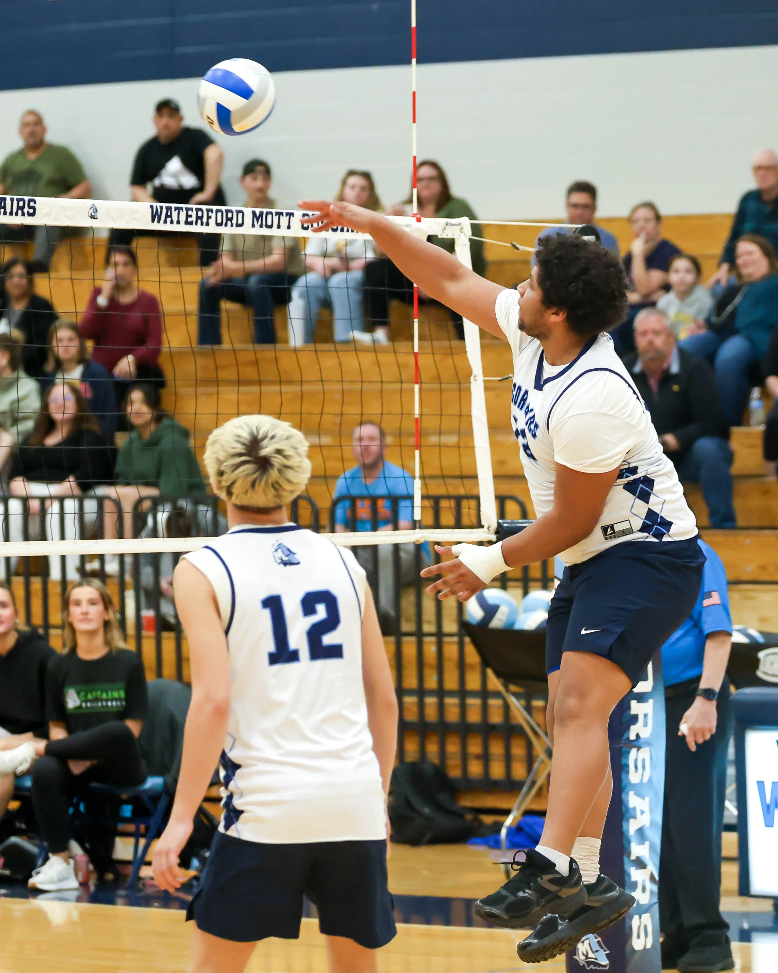 Mott #13 spikes the ball