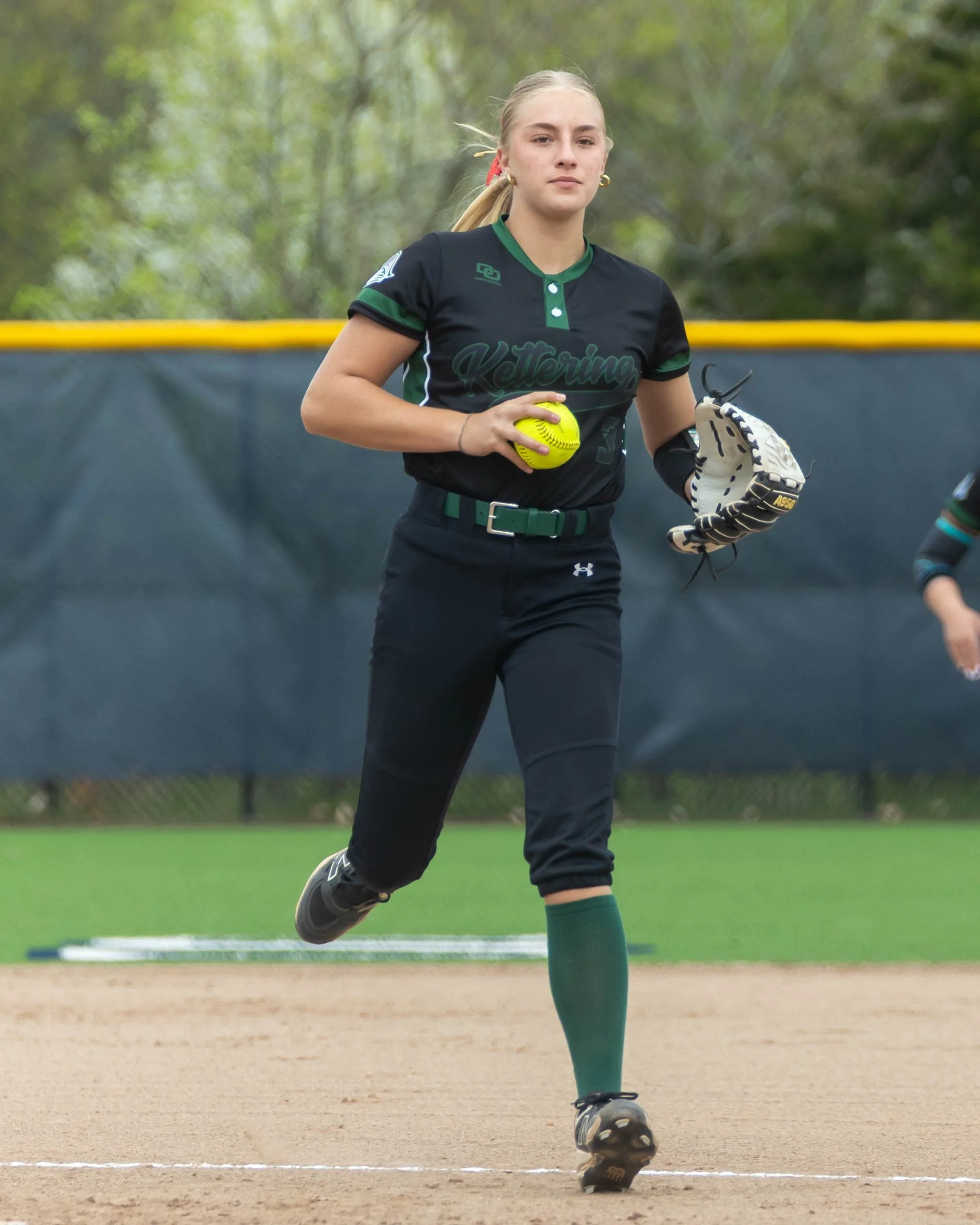 Kettering player runs the ball to the pitcher
