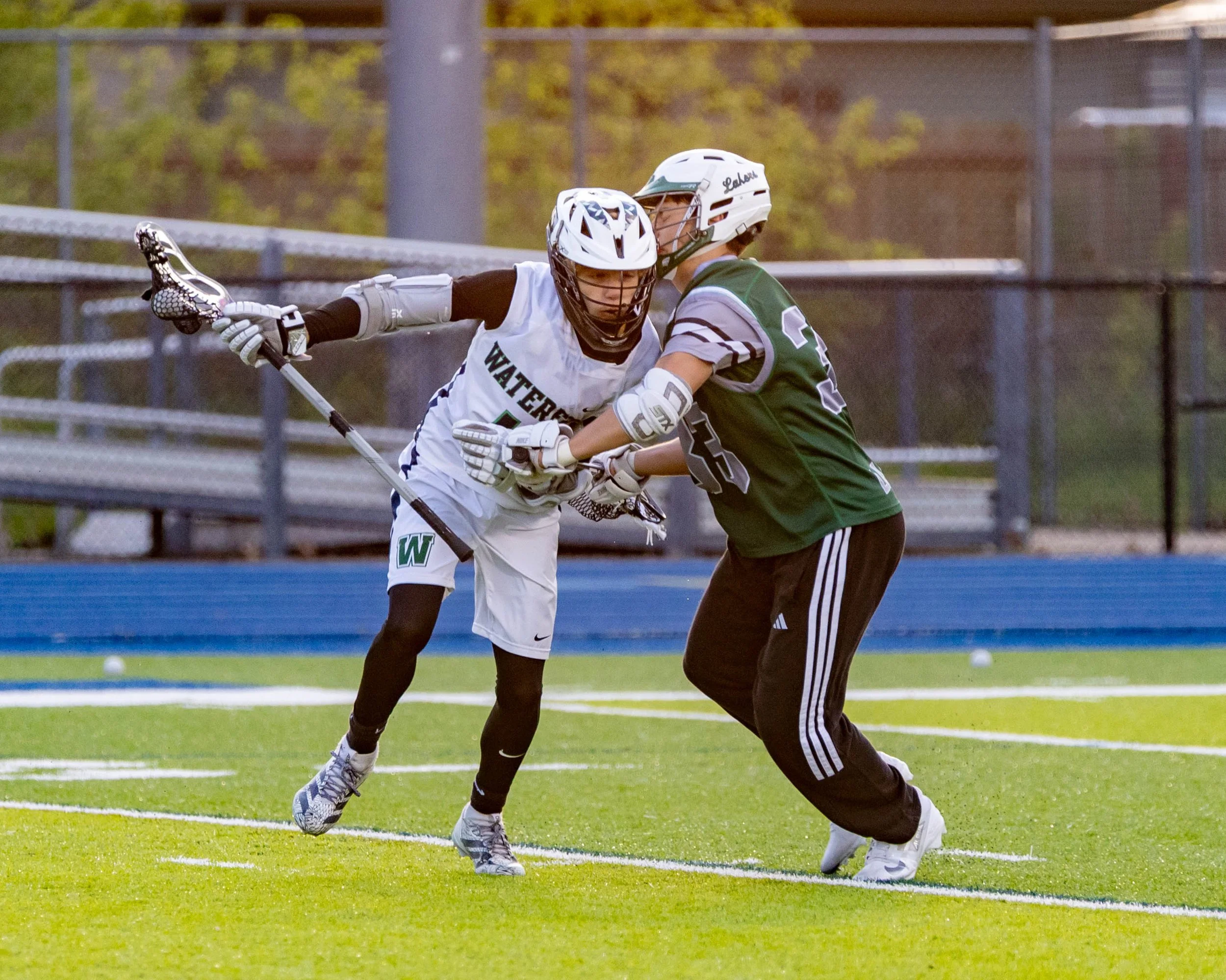 Waterford United player carries the ball against a West Bloomfield player