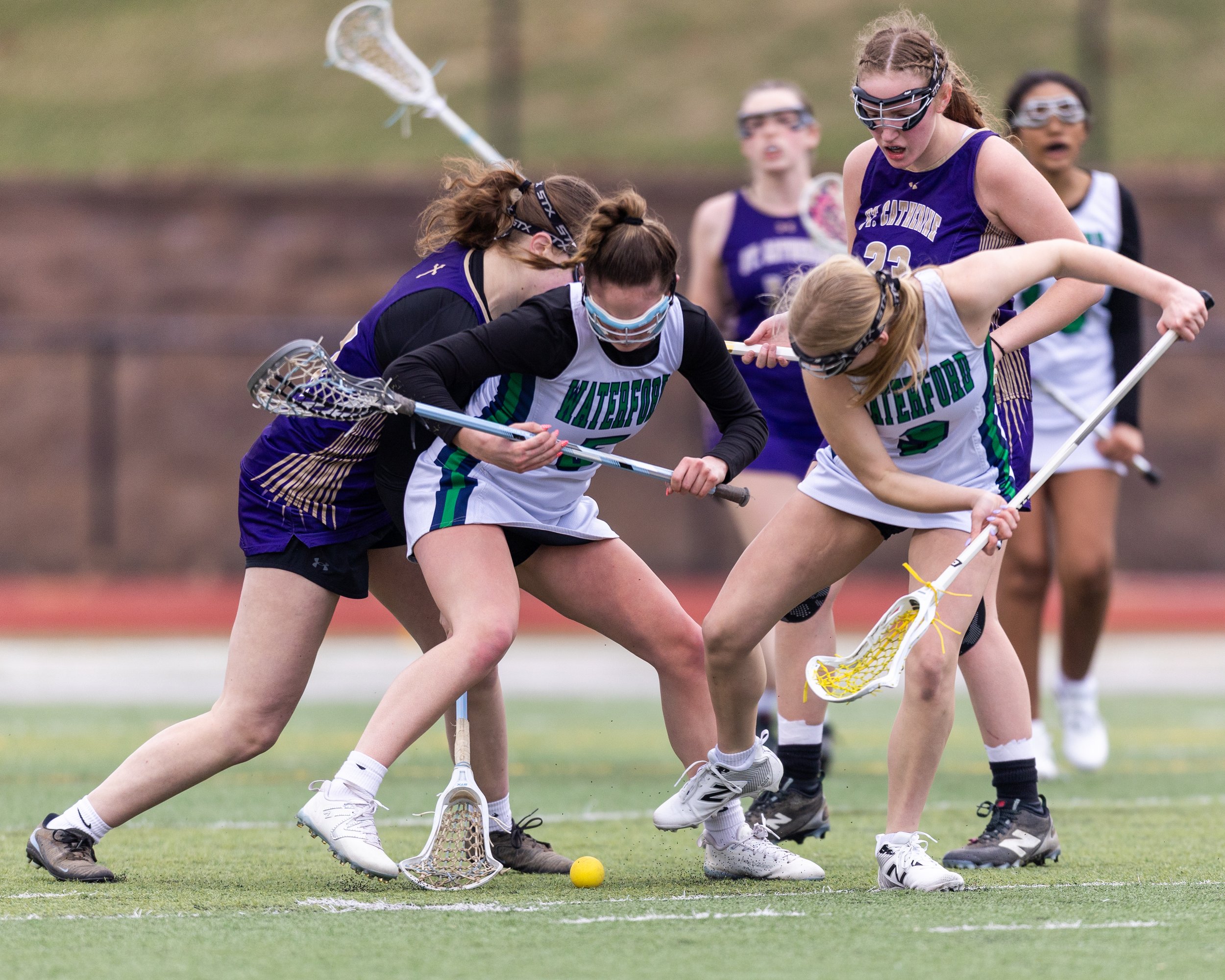 A scrum of Kettering and St. Catherine players around the ball