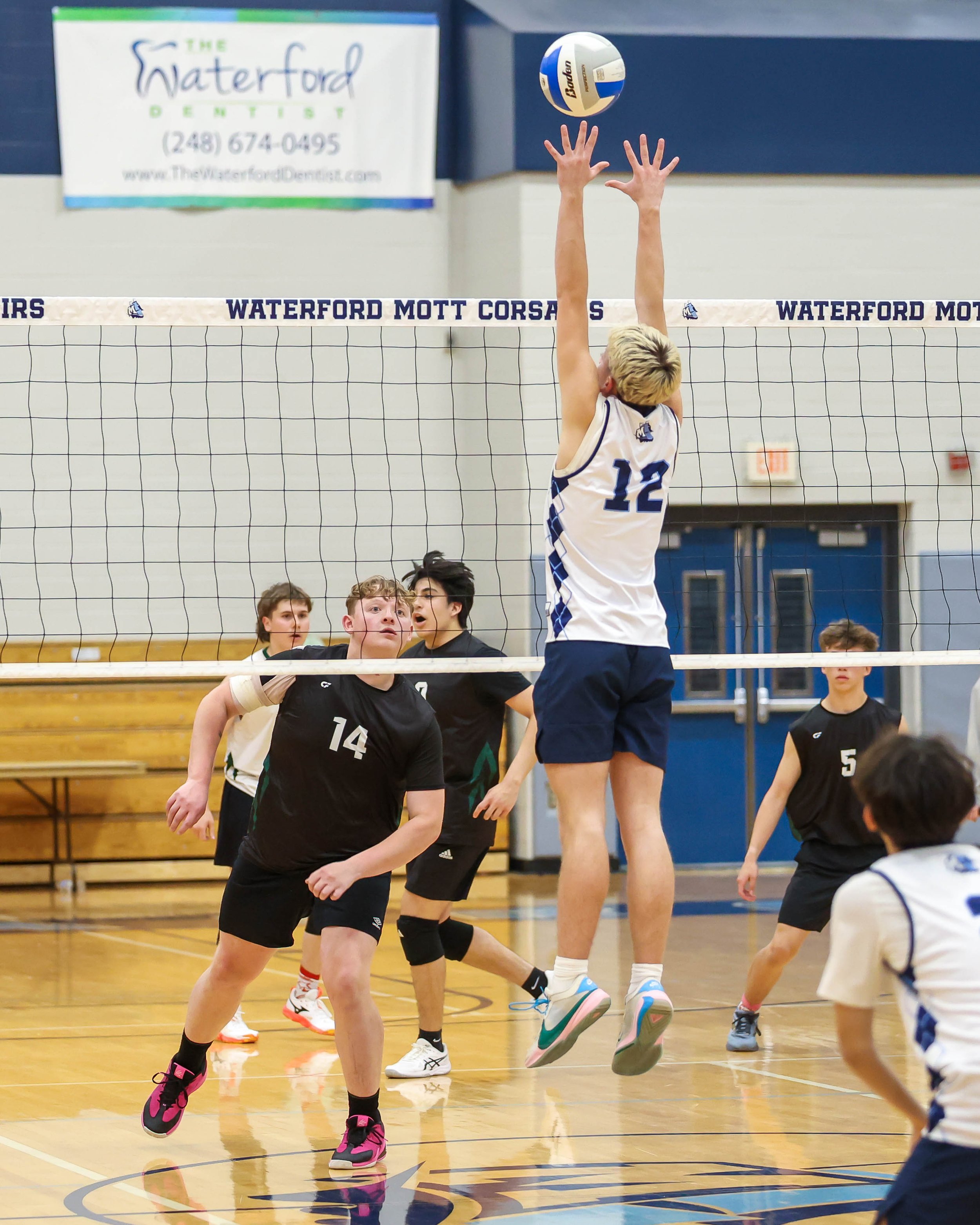 Mott #12 tries to block the ball