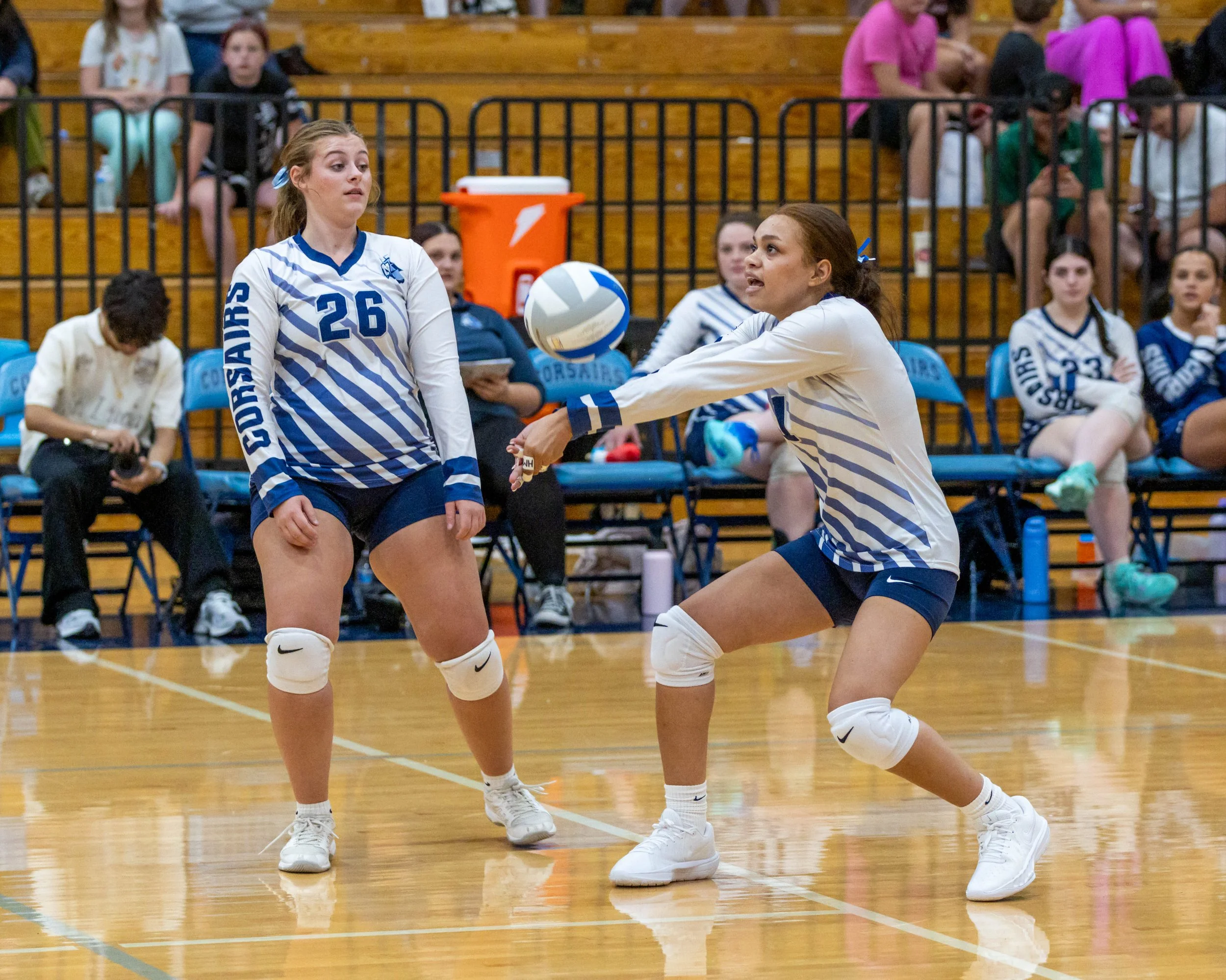 WM #1 hits the ball, as WM #26 watches