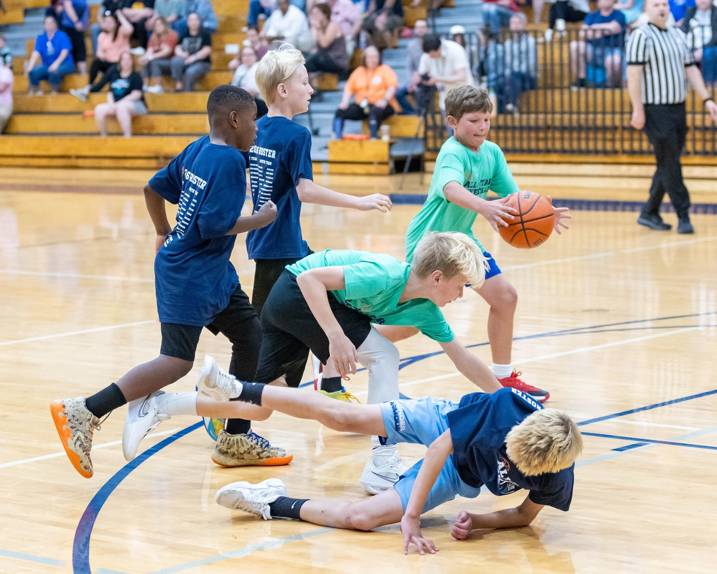 South boy with the ball as boys fall