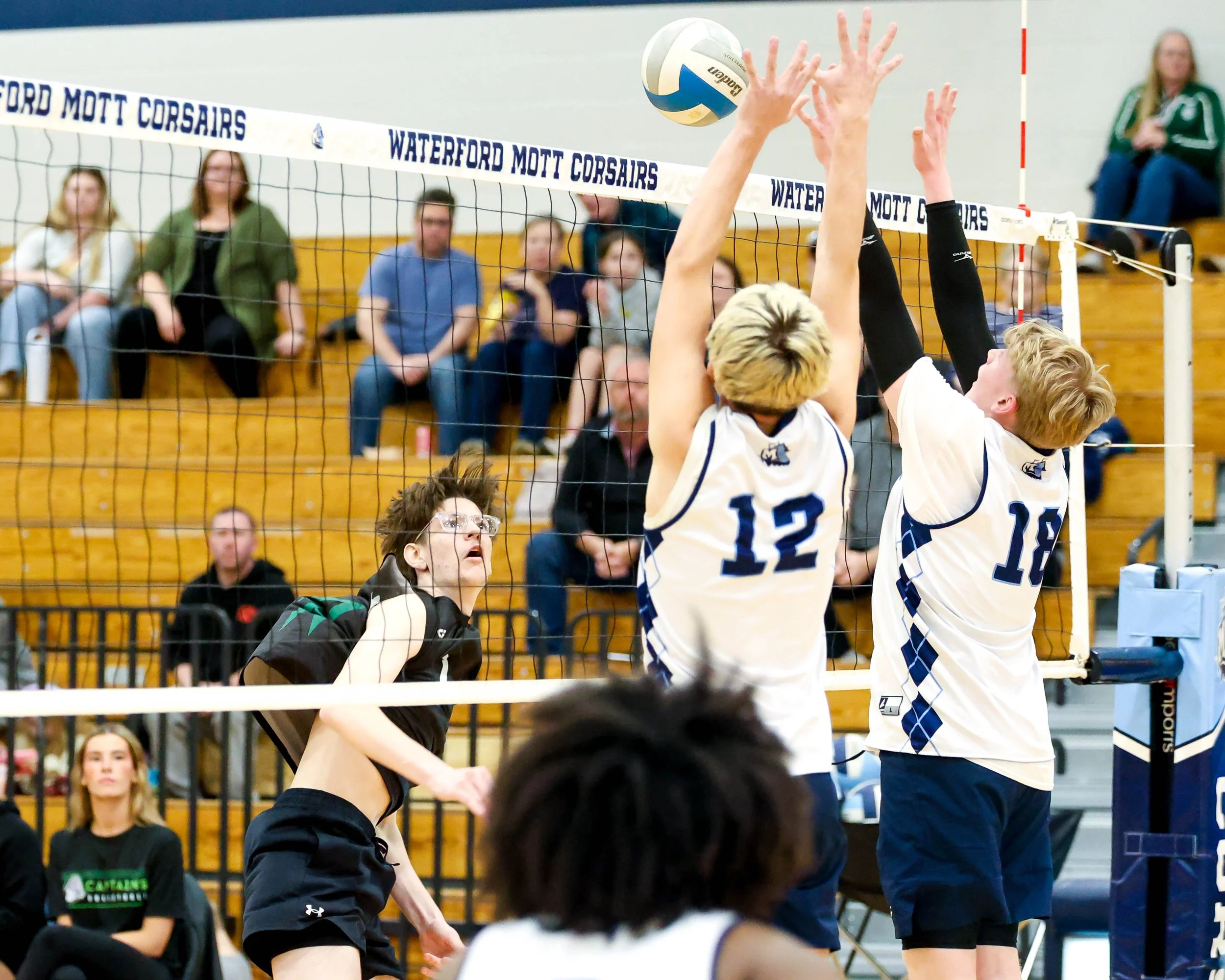 Mott #12 and #18 tries to block the ball