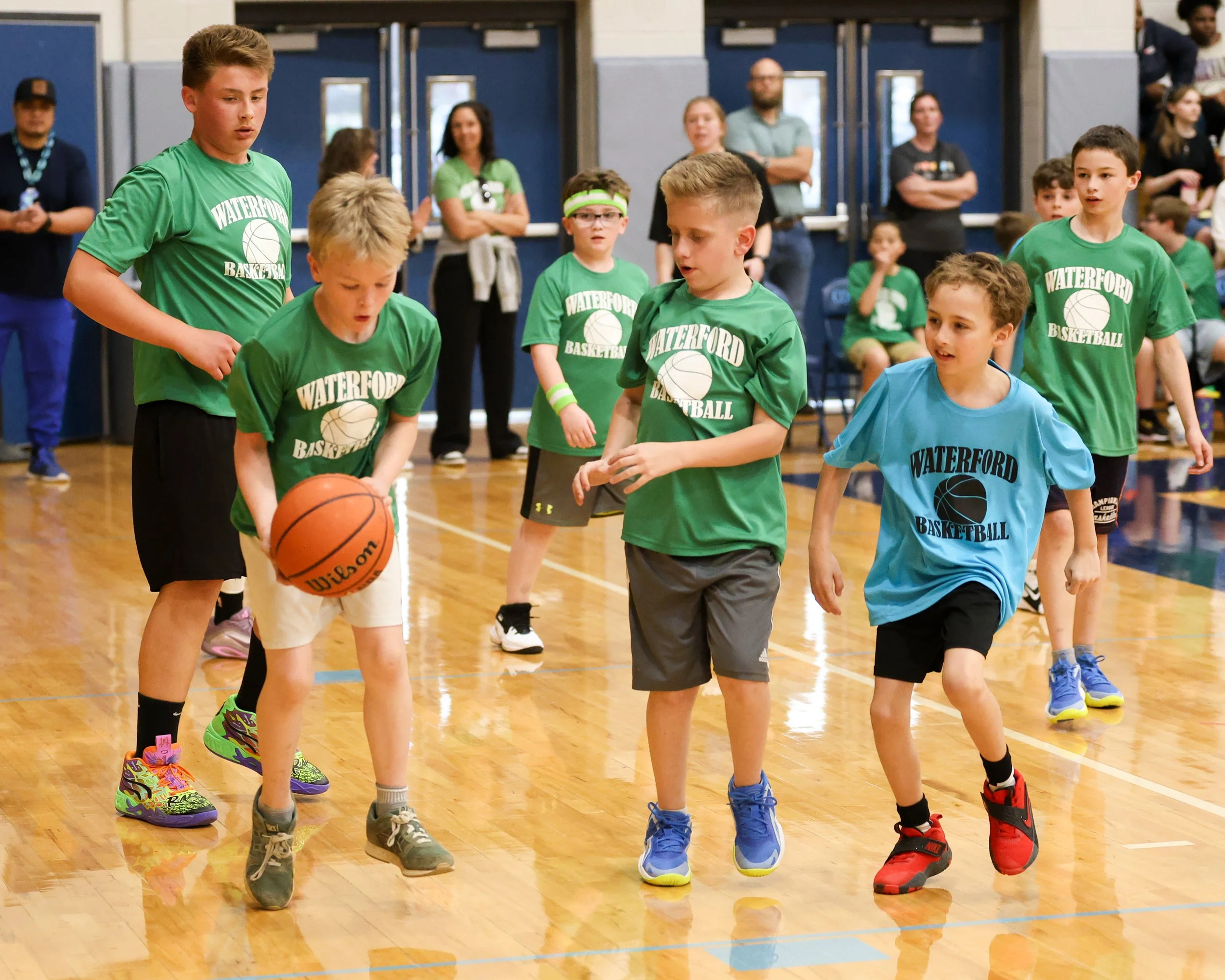 Grayson boy holds the ball with several players around him 