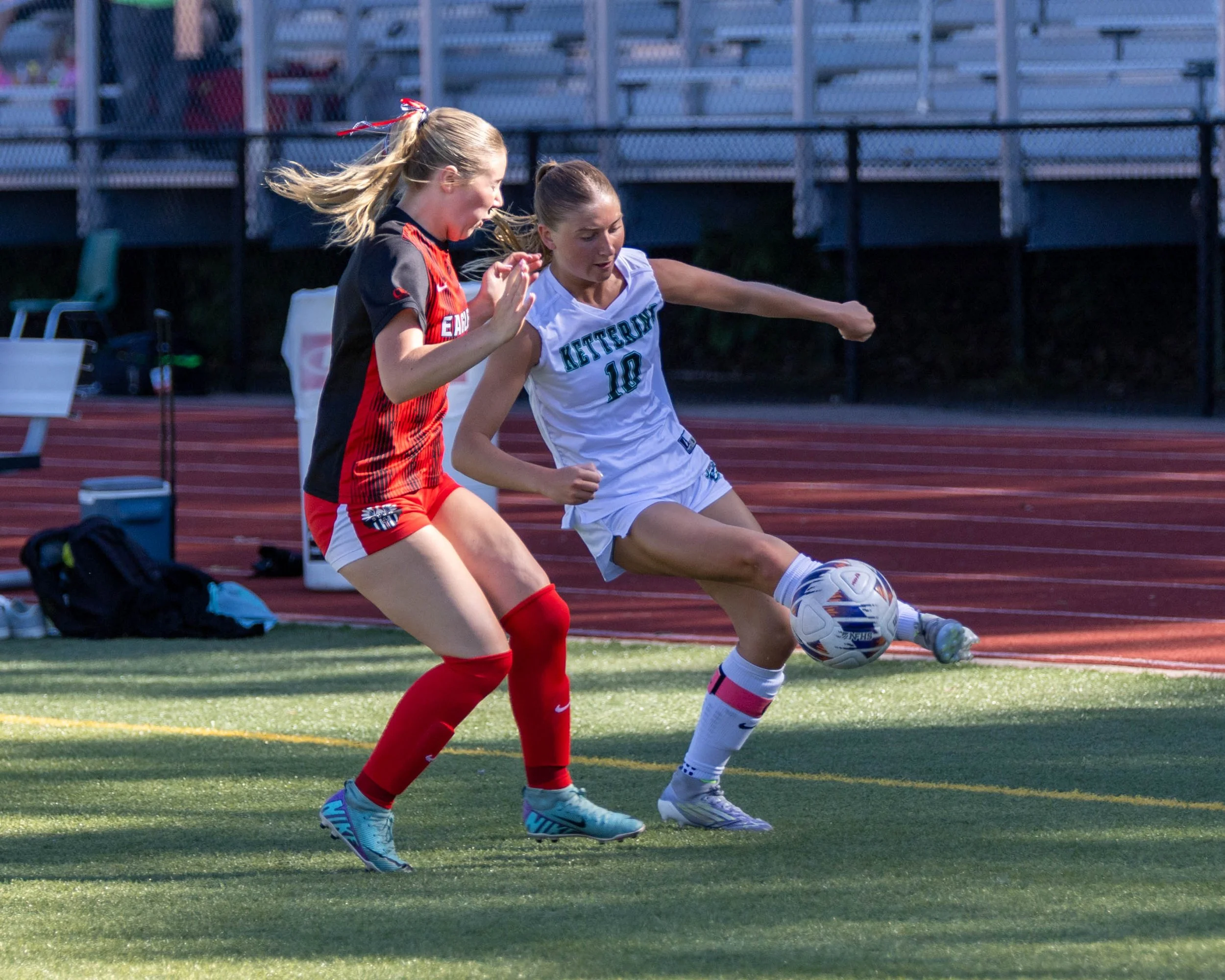 #10 controls the ball with an opponent