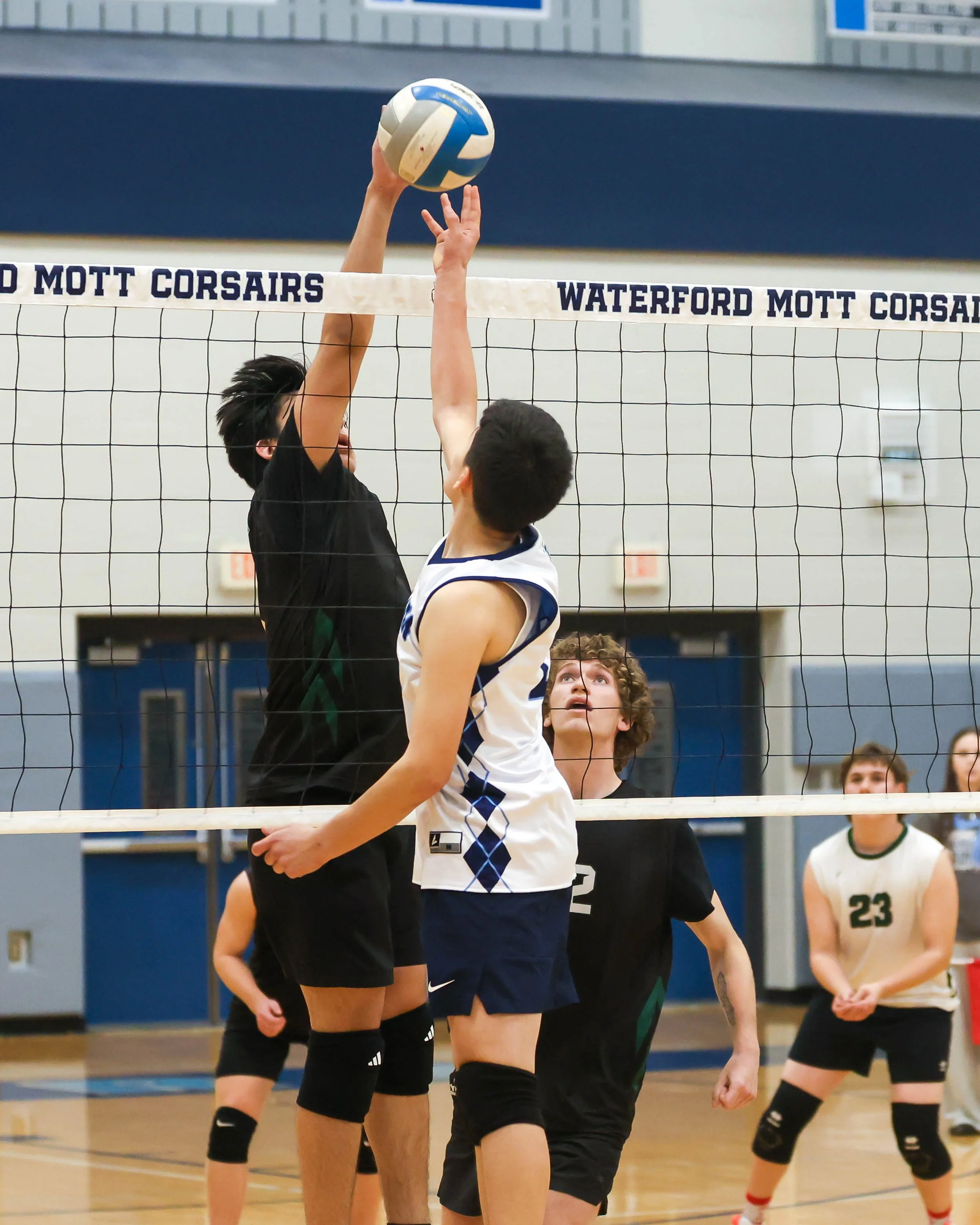Kettering #6 and Mott #10 reach for the ball