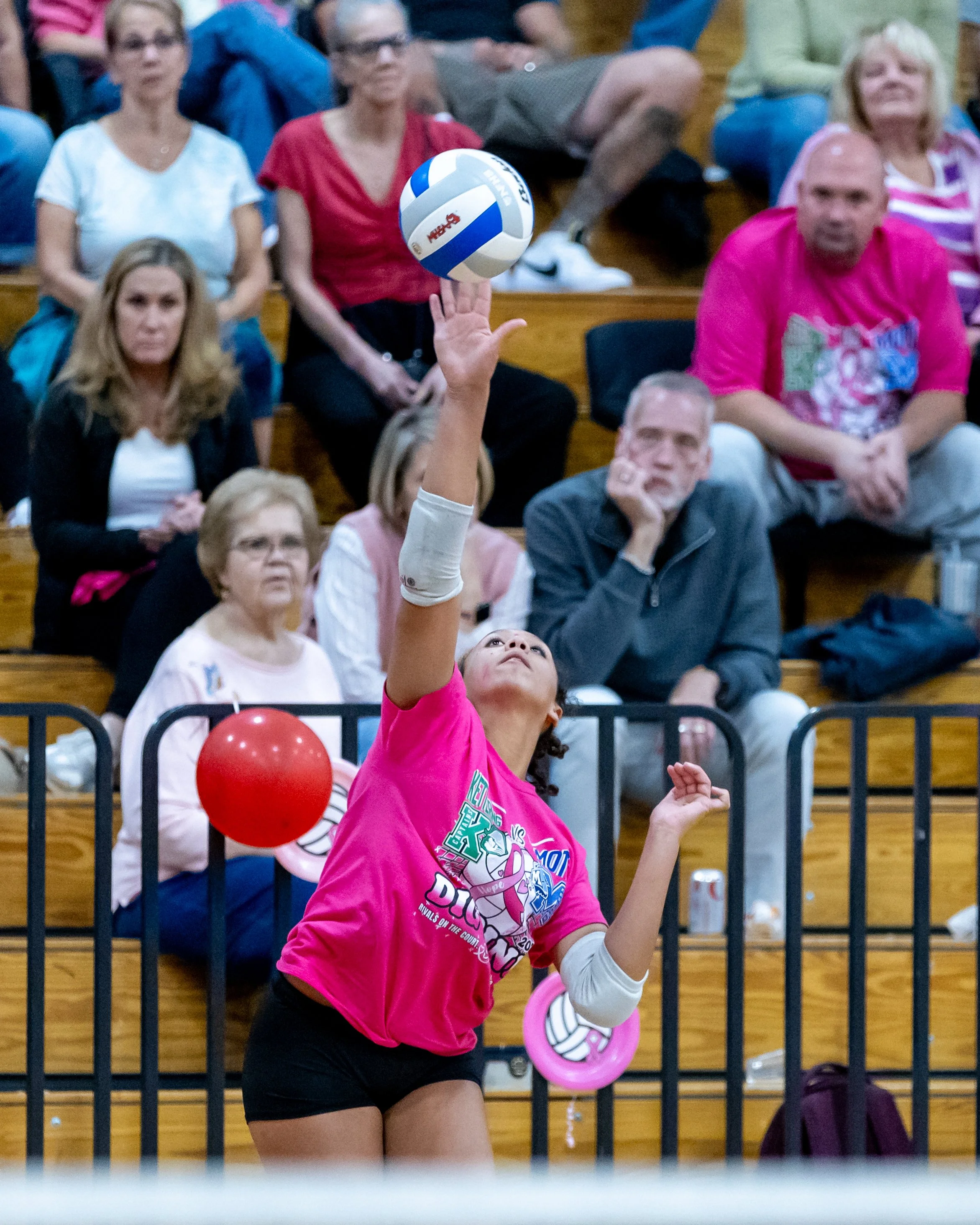 Kettering player serves the ball