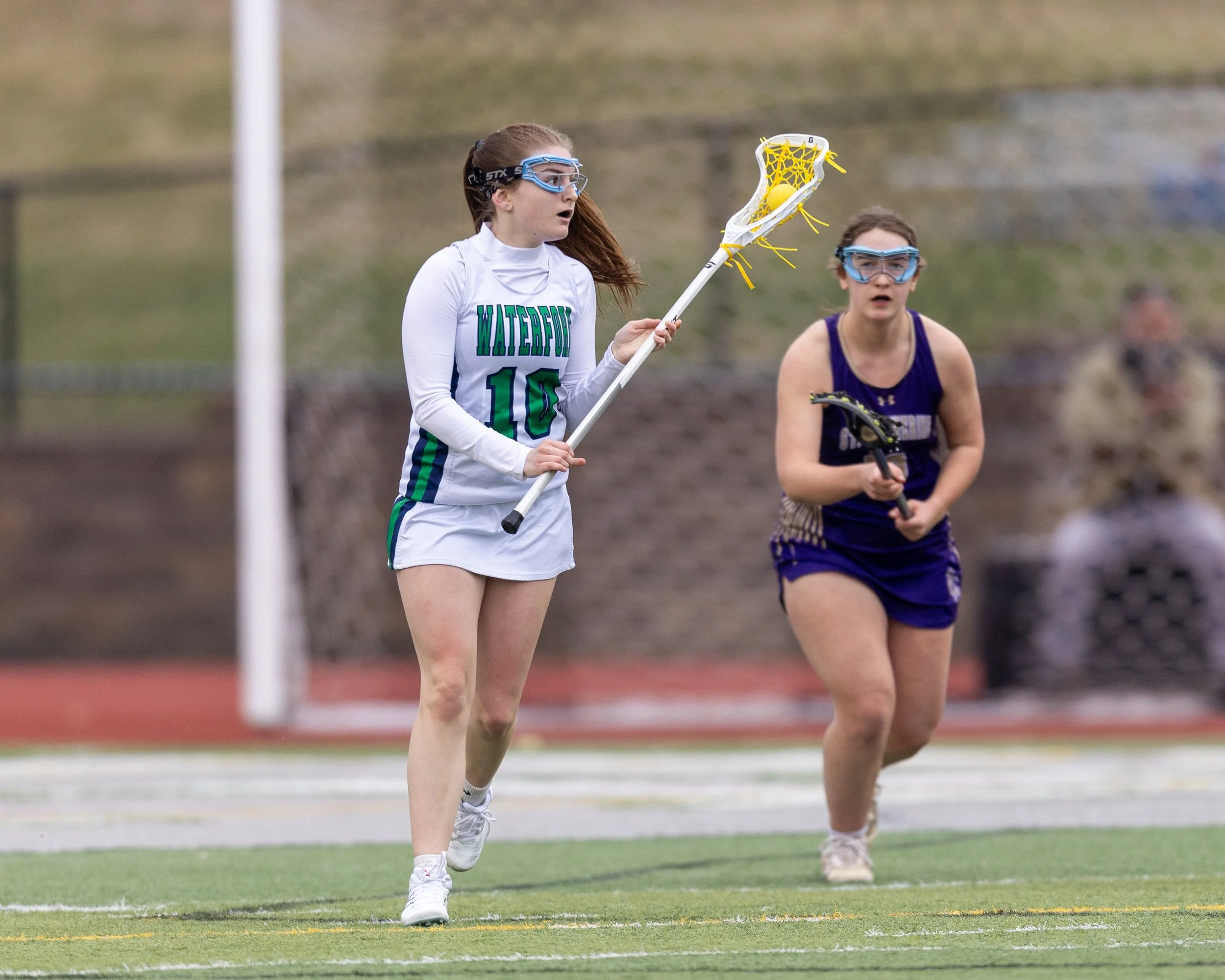 #10 carries the ball around a defender