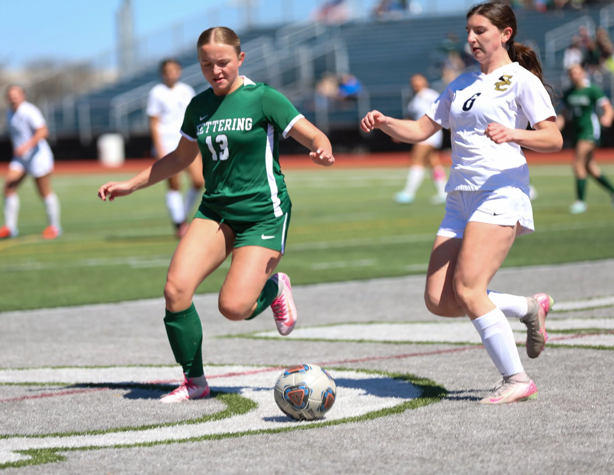 #13 battles for the ball