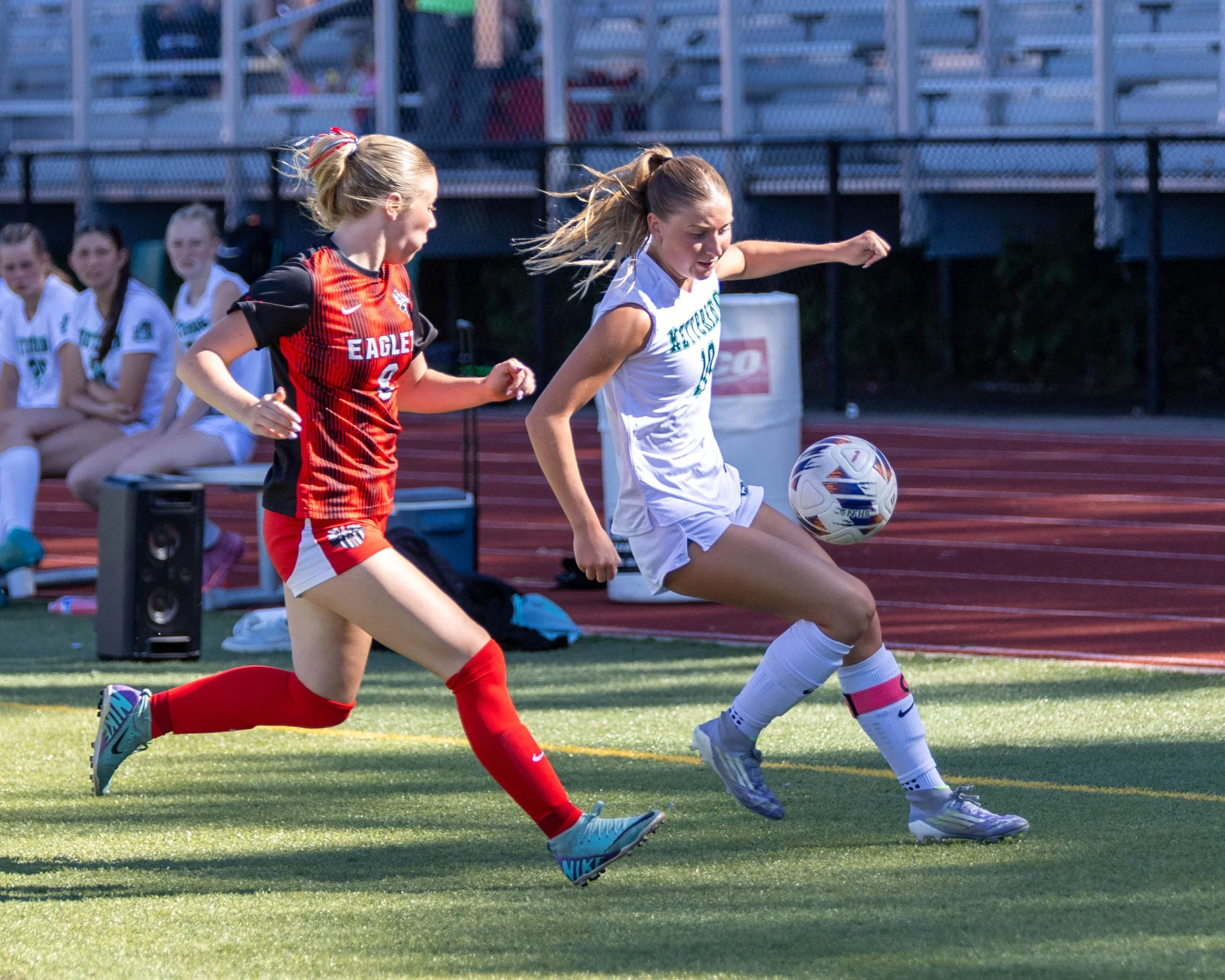 #10 watches the ball with an opponent
