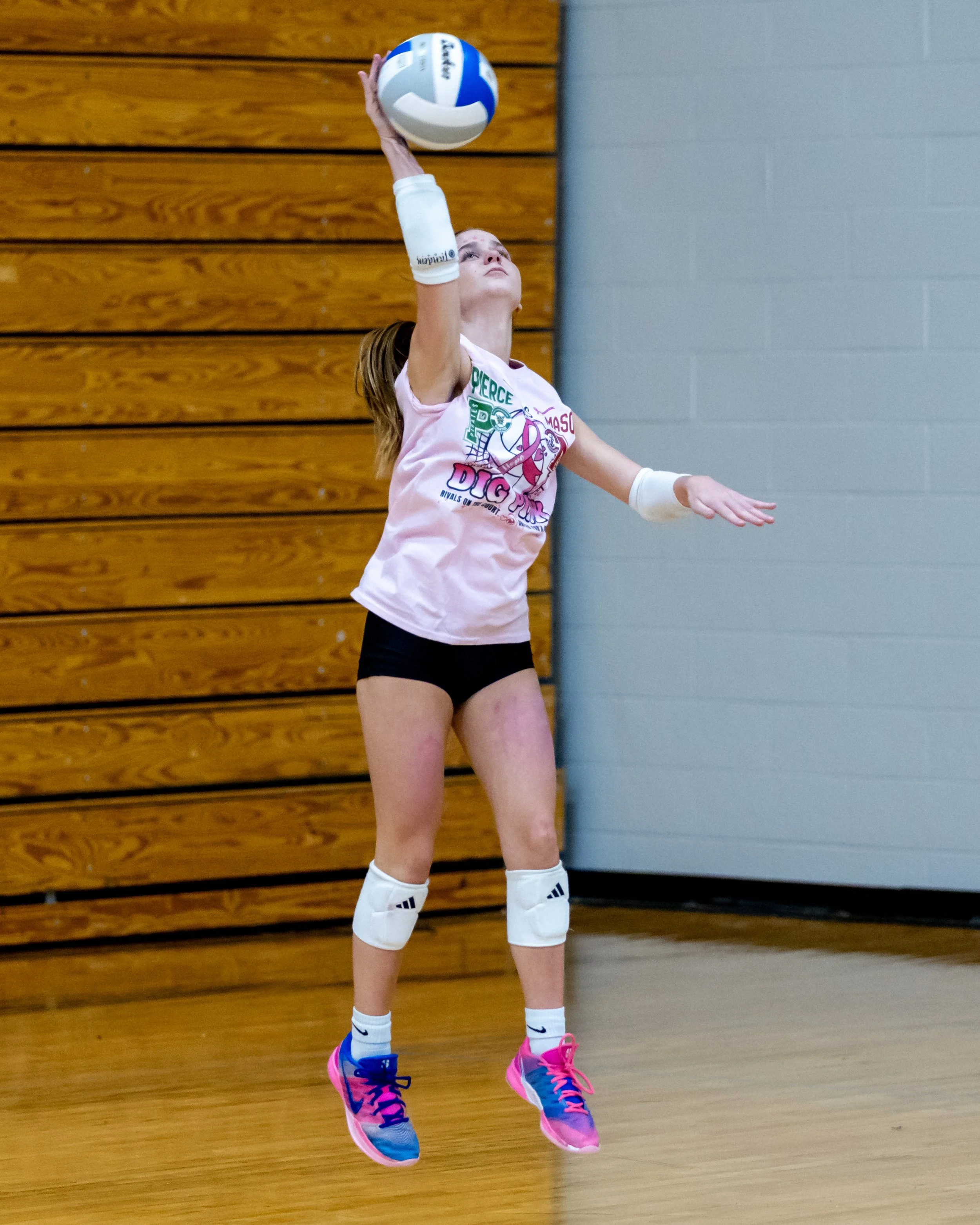 Mason player serves the ball