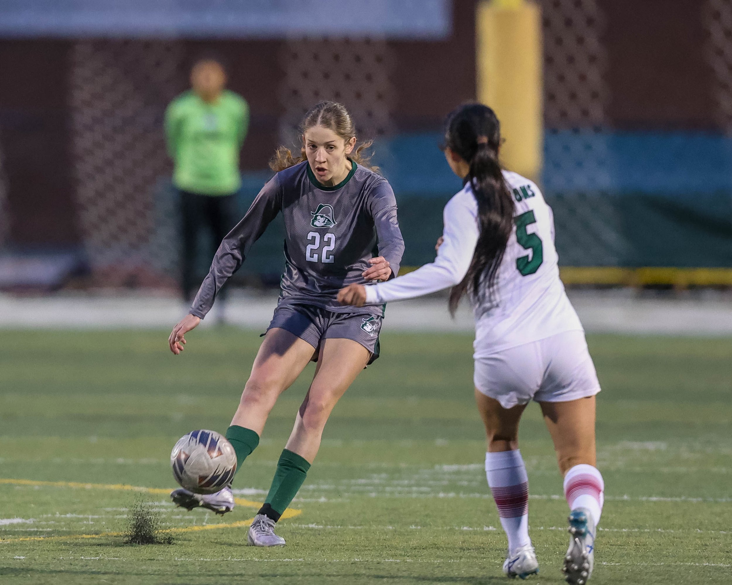 #22 kicks the ball