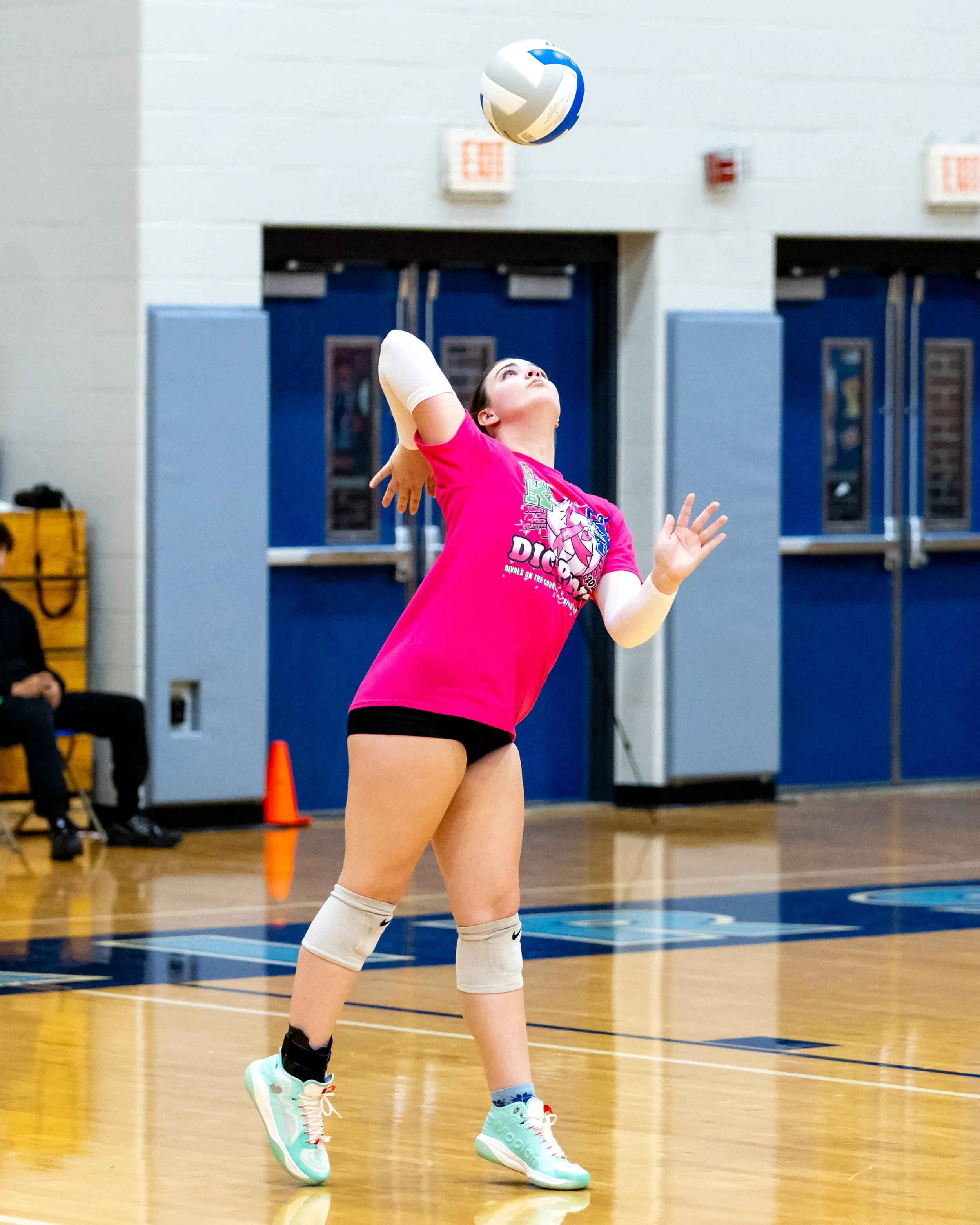 Kettering player serves the ball
