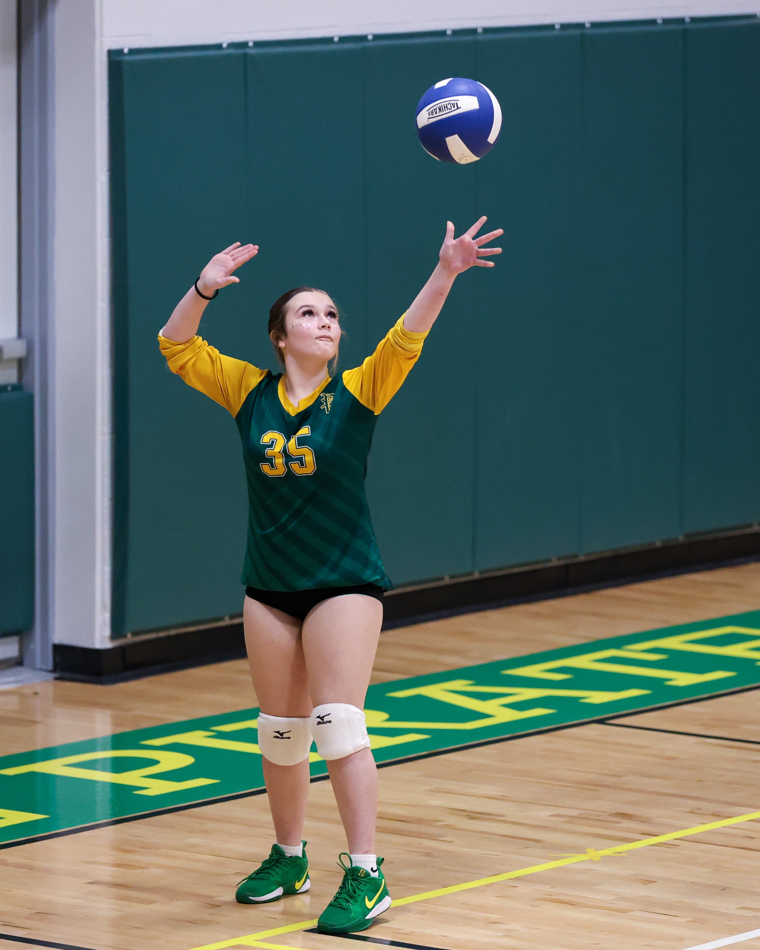 Pierce girl serves the ball