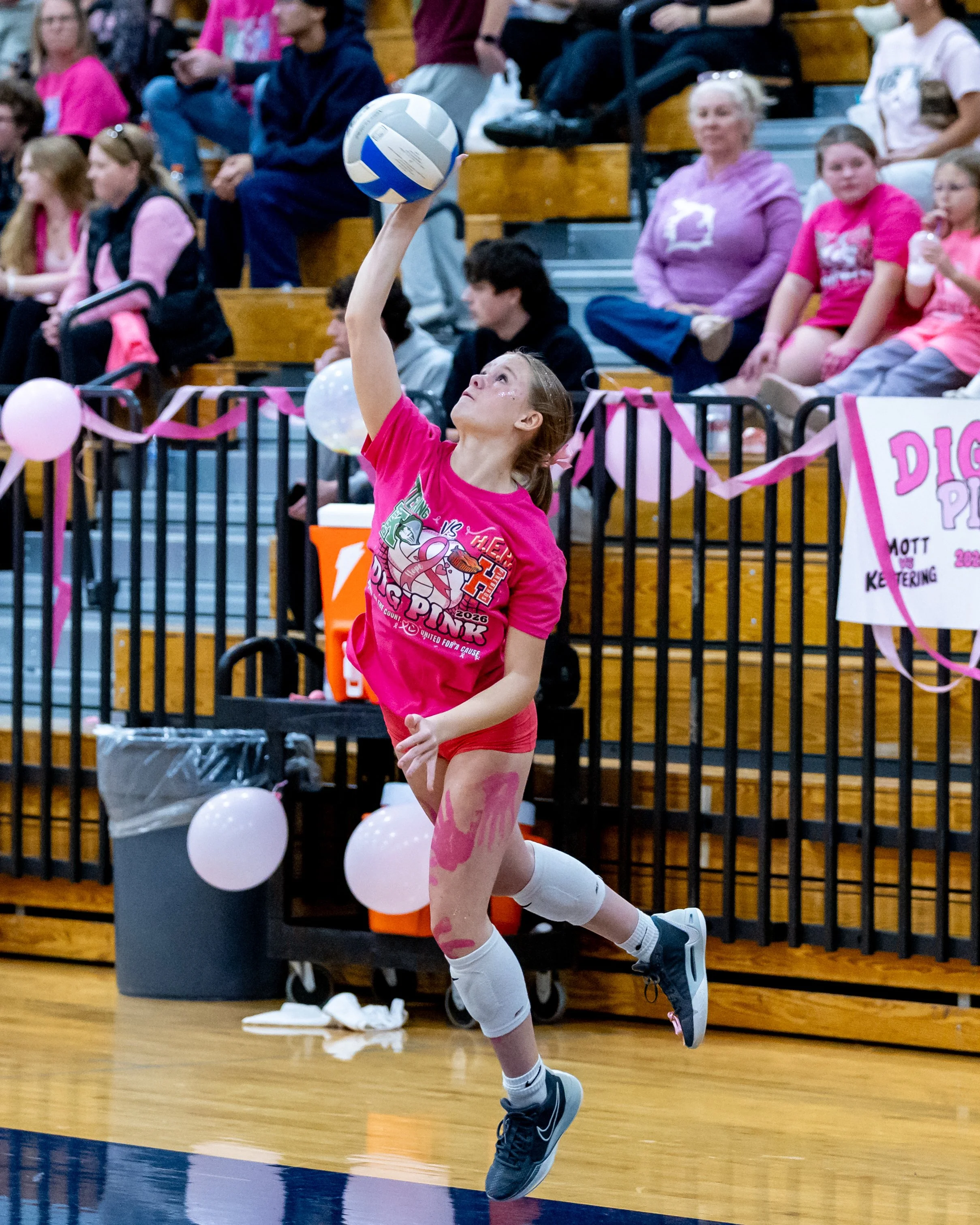 Kettering player serves the ball