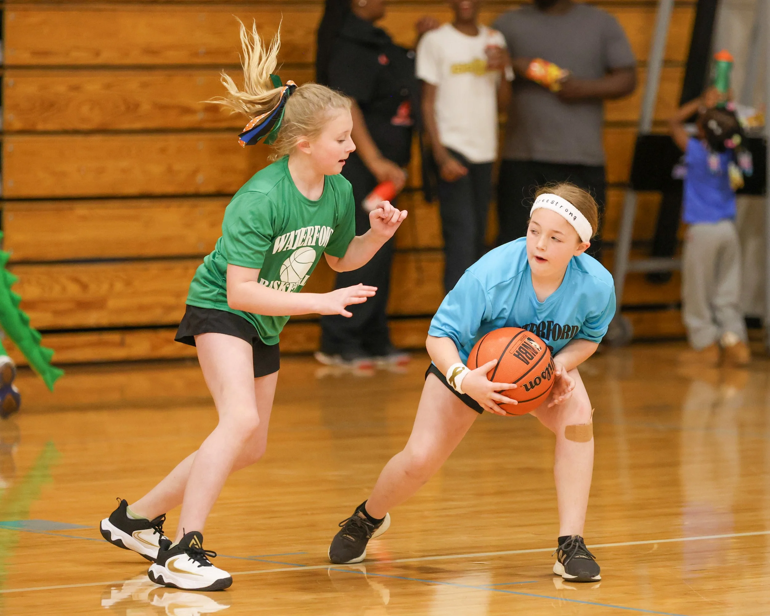 Cooley girl holds the ball with Grayson girl guarding her