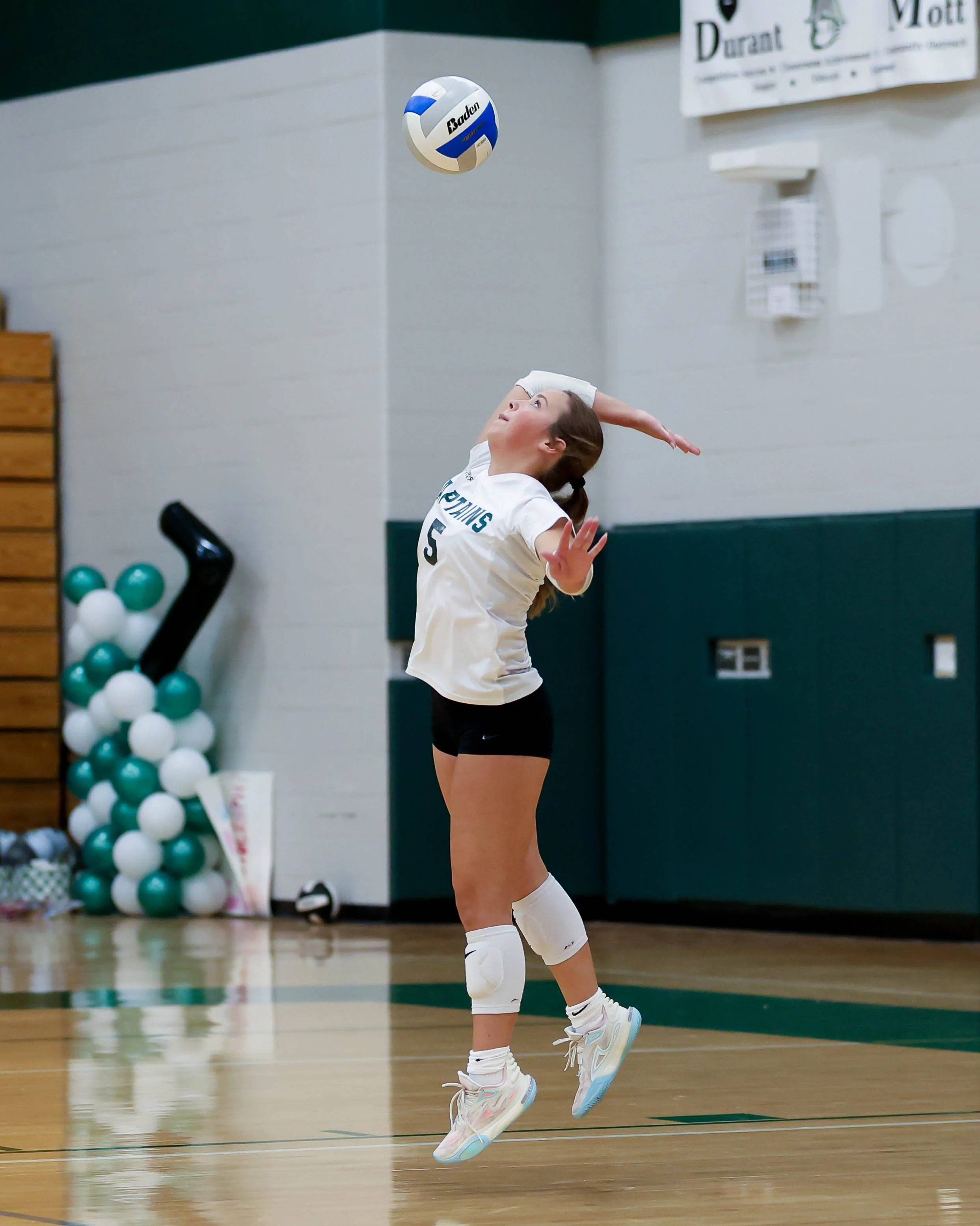 Kettering #5 serves the ball